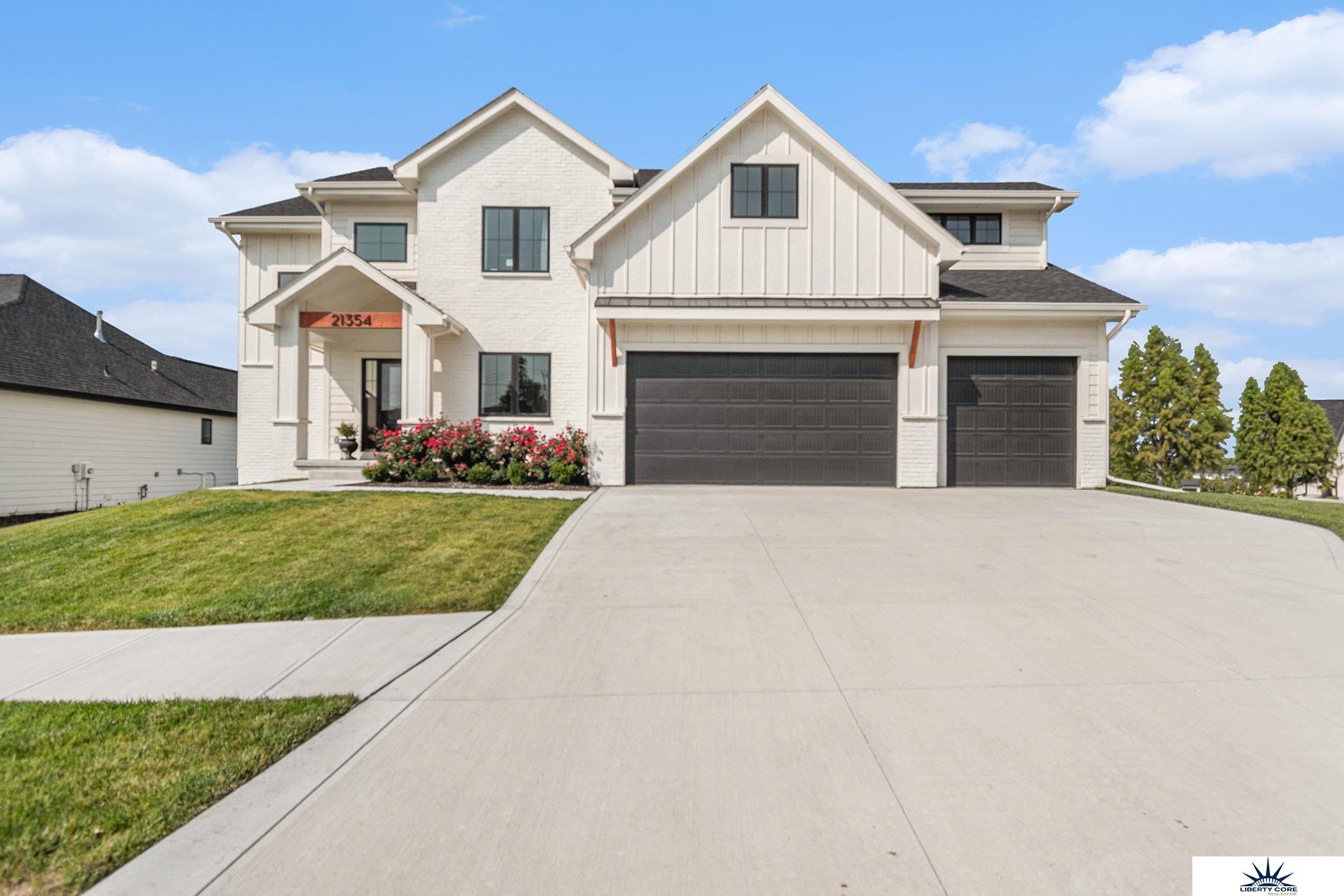 Welcome to 21354 East Circle in Elkhorn! Build in 2023 with upgrades galore, this spacious five bedroom, five bathroom home is perfect for families with its ideal layout. The open living space includes a kitchen, living room, and dinette all connected for easy flow.  Kitchen island seats six. Separate office/ four-season porch with fireplace conventionally located off of kitchen. The flat corner lot offers a beautiful view of a tree lined creek. And the quiet, friendly neighborhood has a walking bridge to Blue Creek Elementary School. Low traffic! With quick access to highways 204th, Dodge, and I-80, this home is conveniently located for all your needs. Don't miss out on this opportunity for a perfectly designed home - schedule a showing today! Agent has equity.