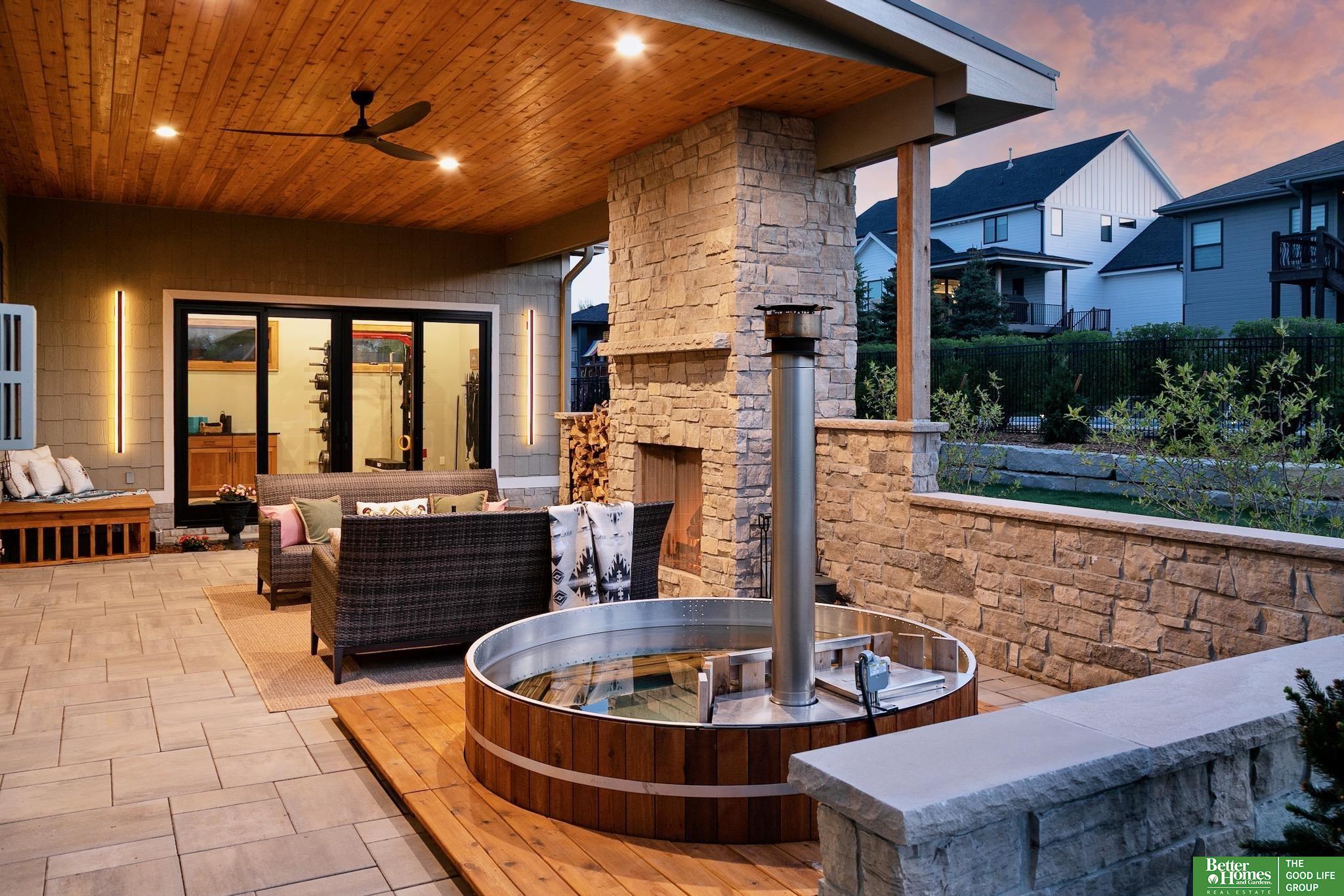Showings start May 1st! This Elkhorn South stunner is truly a “WOW” home! Exceptional quality shines throughout this 5 bed, 5 bath two-story. From the moment you enter, you’ll be impressed by the rich wood flooring, ceiling beam details, and the view of the gorgeous covered patio featuring a natural stone wood-burning fireplace, wood-fired hot tub with privacy wall, and a one-of-a-kind home gym addition. The open-concept great room with gas fireplace flows into a chef-worthy kitchen with top-tier appliances and striking stonework. A main-level office adds flexibility. The spacious primary suite features a private ¾ bath, dual walk-in closets, and direct access to the laundry. Secondary bedrooms offer generous space, large closets, and bath access. The finished lower level includes a family/rec room, 5th bedroom, ¾ bath, wet bar, and hidden Murphy bed. Heated garage w/epoxy-coated floors& car charging capability complete the package. A must-see!