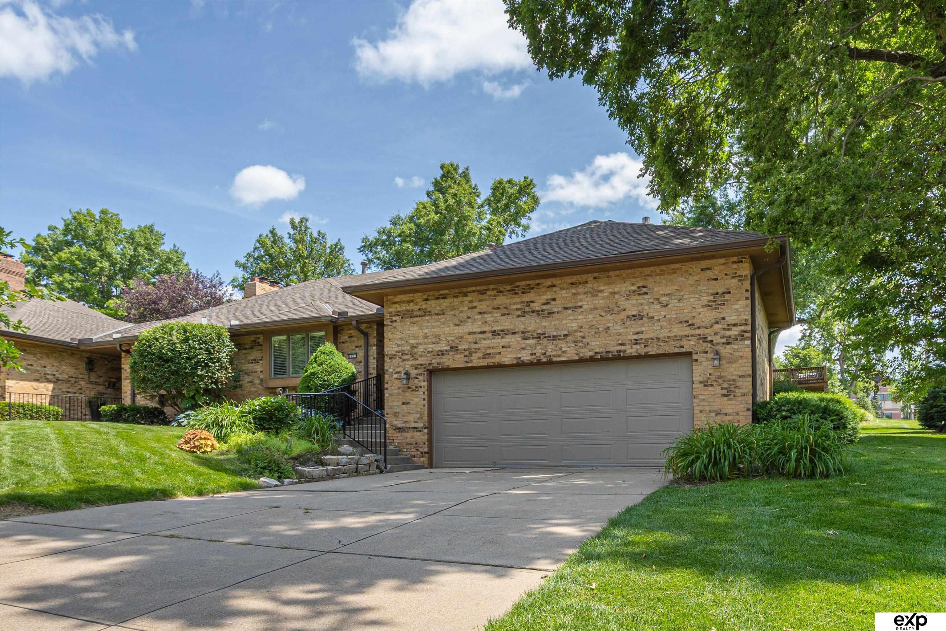 Listed at $75,000 below appraised value! A rare 1.5-story townhome in the coveted Fairacres neighborhood. Just minutes from all Dundee, Aksarben and Memorial Park have to offer. This home offers unmatched convenience in a prime Omaha location. Featuring two spacious living rooms—including an upper-level retreat with tray ceiling, original woodwork, and a cozy fireplace. With 3 bedrooms plus 2 non-conforming bedrooms in the finished basement, there's plenty of space for guests, a home office, a workout room or space for hobbies. 4 full bathrooms! Home is ADA friendly with an elevator in the garage, zero entry shower and widen doorways. Enjoy summer evenings on your private patio with access from the dining room or primary bedroom. Enjoy a low-maintenance lifestyle with lawn care and snow removal included in the HOA. A rare find in a sought-after area! Home is pre-inspected but sold as-is.