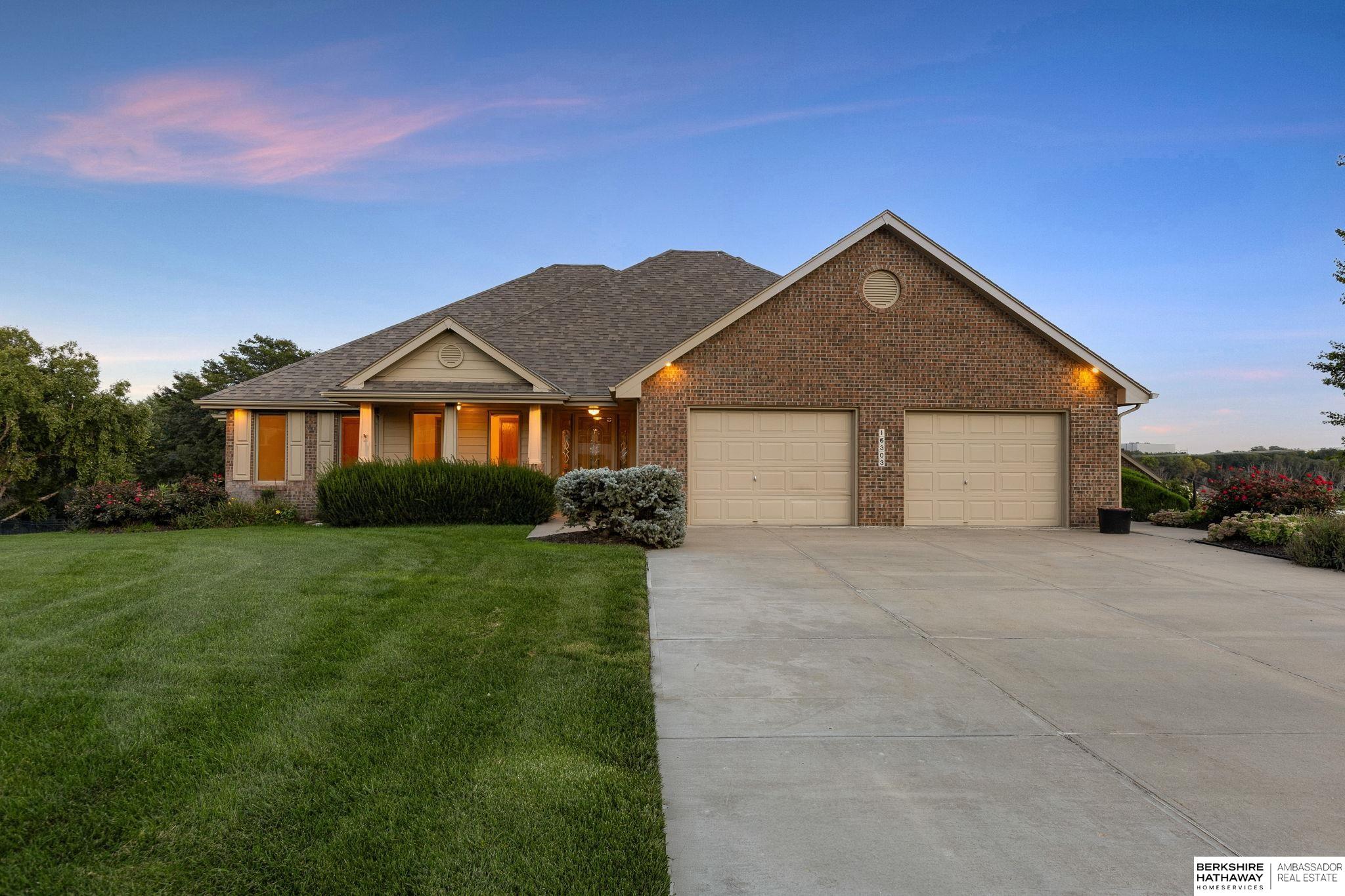 Welcome to this unique acreage that truly has it all. Not only does the property feature an additional heated garage with RV access, but it also backs directly to the Chalco walking trail, offering endless opportunities for recreation right outside your backyard. Inside, you'll find a spacious kitchen complete with a large pantry - perfect for cooking and entertaining. The open lower level expands your living space with its own kitchen, making it ideal for hosting parties and holidays. The property's location combines peace and convenience-with easy access to Highway 370 and I-80. Perfectly situation for shopping and dining ease. This home offers a rare blend of acreage living, modern amenities, and unmatched convenience.