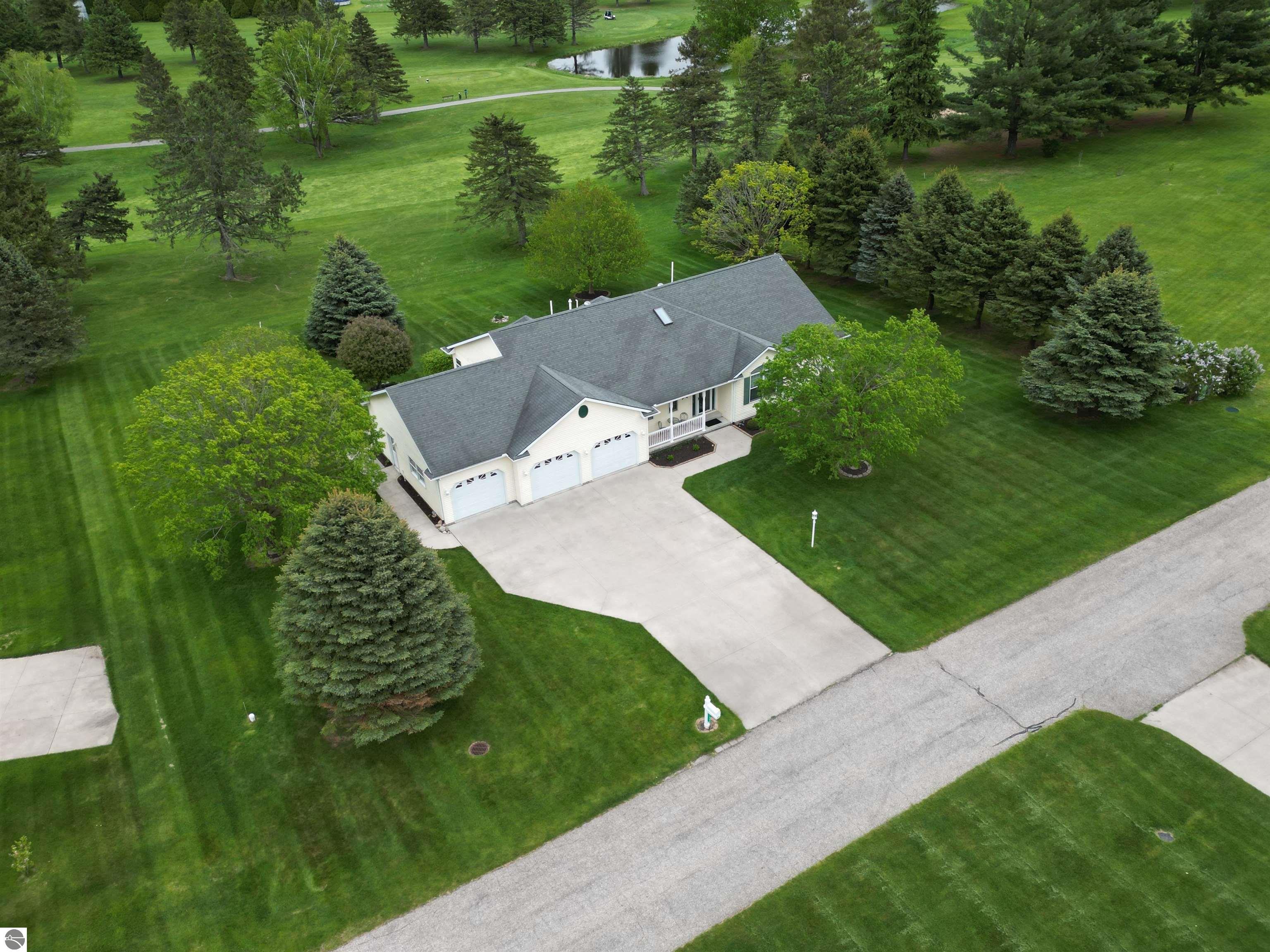 CHIC - ELEGANT - SPACIOUS!  Step into this warm and welcoming home. Impeccably maintained. The living area, kitchen, and dining area feature an open concept that allows lots of natural sunlight, creating the ultimate space for family gatherings and making lifelong memories. The deck provides still more space, spanning the length of the house and overlooking the fairway.  A comfortable master suite features a walk-in closet, a spacious bathroom and a private office nook. And there are so many extras...covered front porch, foyer entry, solid oak doors, bay windows, tray ceiling, skylight, kitchen island. All appliances are included. The walkout lower level offers more living space opening to a 12 x 31 patio and lush landscaped yard with an irrigation system. The family room and bedroom make a flexible living space for family or guests. The 17 x 33 storage room provides great storage or room for expansion. ADT Security System and Millbrook Water System. Attached 3-car garage. Double lot with 180' on the fairway of hole 7 at the Pines Golf Course. Includes access to 800-acre Lake Isabella with association docking space available. This is your opportunity to own a premier golf front home in Central Michigan. Don't miss out on this opportunity!