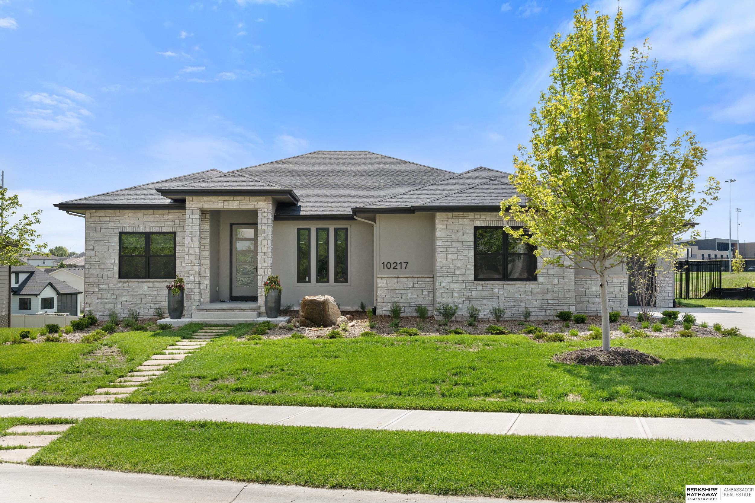 This stunning ranch-style home is nestled in a quiet cul-de-sac in southwest Omaha. This thoughtfully designed 4-bedroom, 3-bathroom residence offers over 3,000 square feet of beautifully finished living space, including a dedicated home office and a versatile flex room - ideal for a home gym, playroom, or hobby space. Car enthusiasts will be thrilled by the oversized 4-car attached garage with extra-tall ceilings, providing ample room for car lifts and extra storage. Inside, you'll find high-end finishes and practical upgrades throughout, including a spacious master suite with a walk-in closet and a luxurious en-suite bath. The heart of the home is the open-concept kitchen featuring a massive walk-in pantry, perfect for storage and organization, as well as a large island ideal for entertaining. A well-appointed mudroom off the garage entry includes built-in shoe storage and a bench, making daily routines a breeze. Enjoy the professionally upgraded landscaping. Agent has equity.