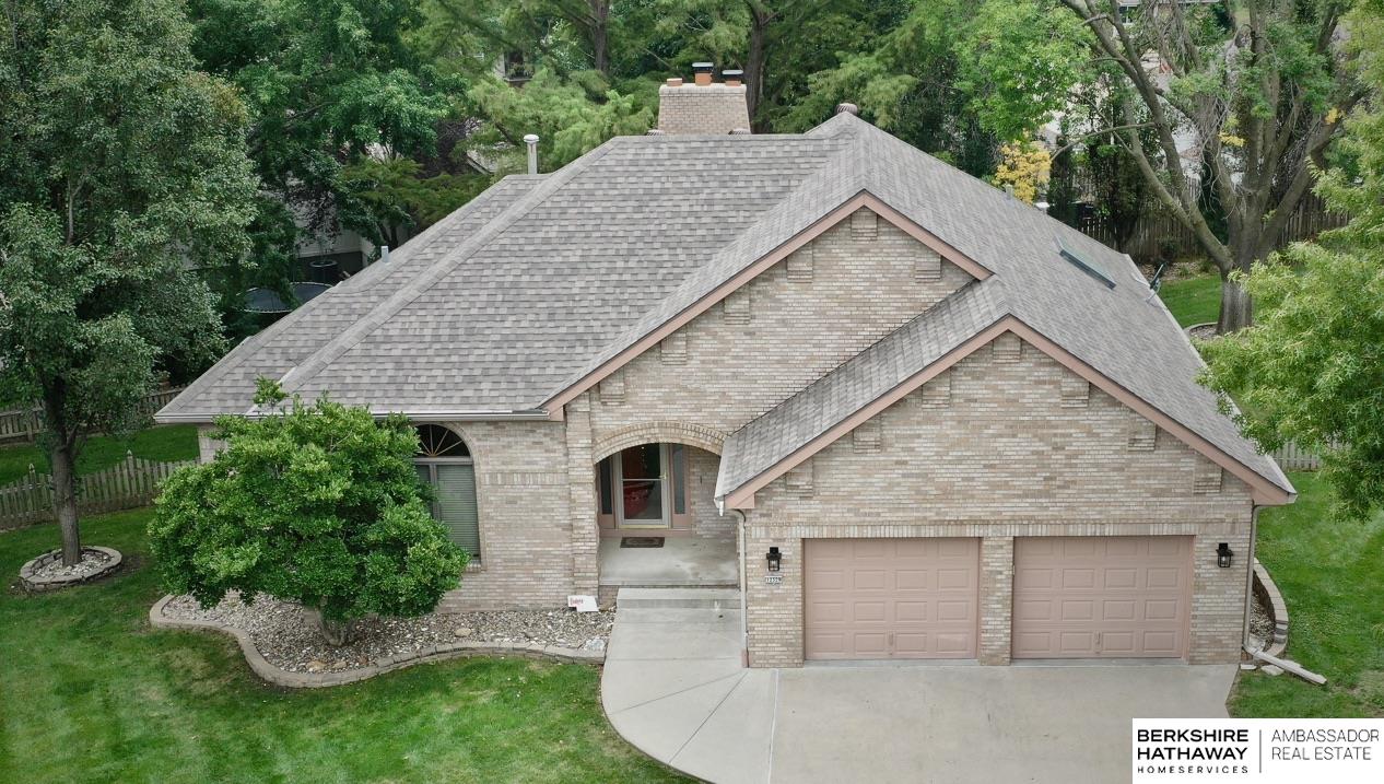 Candlewood Lake - True 4-bed Ranch on cul-de-sac in heart of the city. Experience this beautifully maintained home tucked away on a quiet cul-de-sac near Candlewood Lake in West Omaha. Featuring 4 bedrooms, 3 baths, and nearly 3,000 finished sq ft, this property blends comfort, style, and a stunning natural setting. The main floor offers warm, inviting living spaces including a formal dining area, an open kitchen with custom tile details, and a cozy family room with fireplace. Two bedrooms, including the primary suite with walk-in closet and double-vanity bath, are conveniently located on the main level. The finished lower level adds two additional bedrooms, a spacious rec room, full bath, laundry, and ample storage. Step outside and experience the massive park-like backyard surrounded by mature trees and lush landscaping, a true retreat in the city. The attached garage features a durable epoxy-coated floor and excellent storage. Move-in ready and ideally located near the lake & parks.