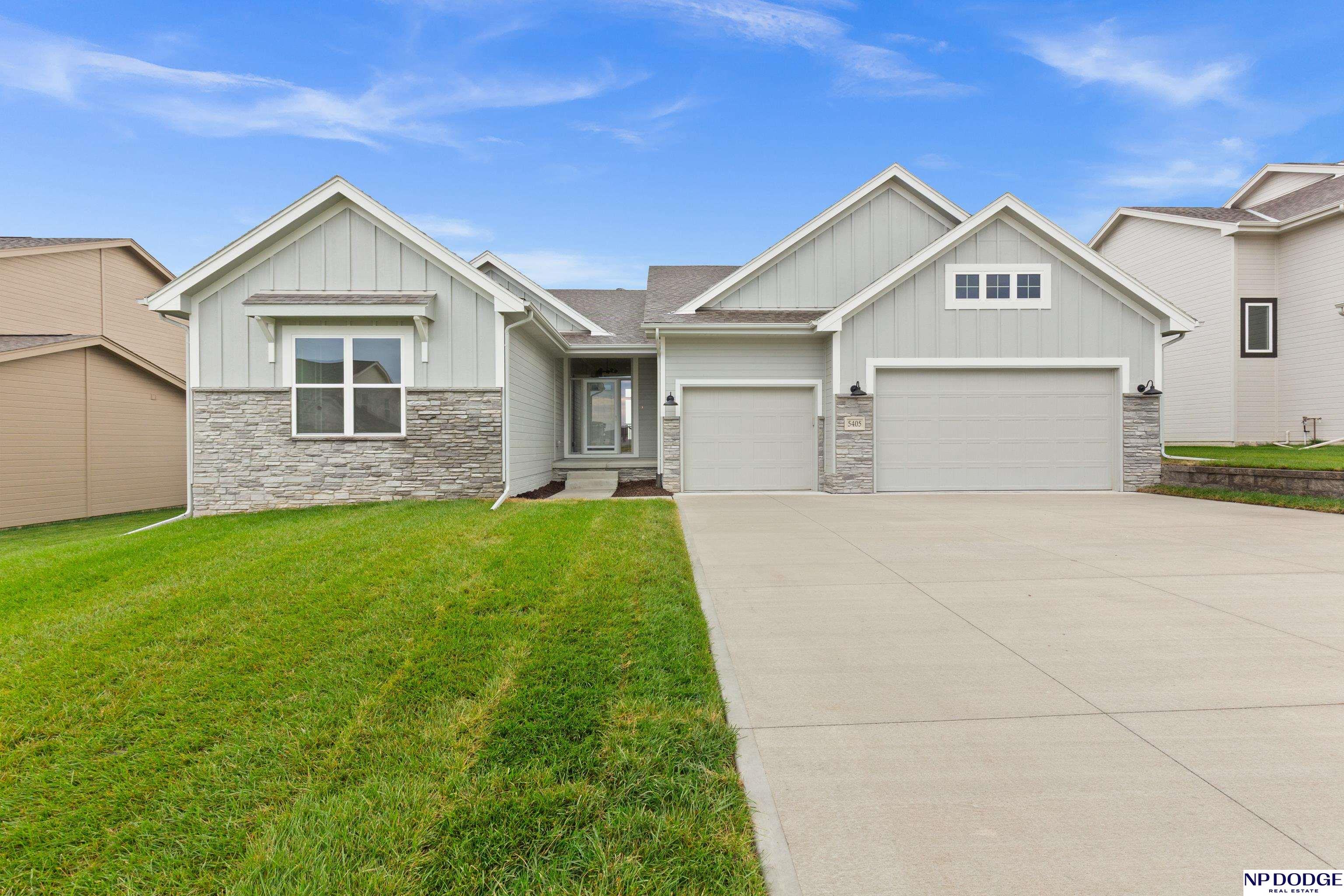 Brand-new ranch home blending style, comfort, and convenience! This 5-bedroom, 3-bath beauty features an open floor plan with a stunning family room highlighted by large windows, a statement fireplace, and floating shelves. The kitchen impresses with a center island, gas range with stainless hood, and a walk-in pantry with handy Costco door for easy grocery unloading. The spacious primary suite offers a designer ceiling, dual sinks, walk-in shower, and a huge walk-in closet. Downstairs, enjoy a finished basement with two additional bedrooms, full bath, and plenty of storage. Oversized 3-car garage and large closets throughout. Perfect combination of function and modern elegance!