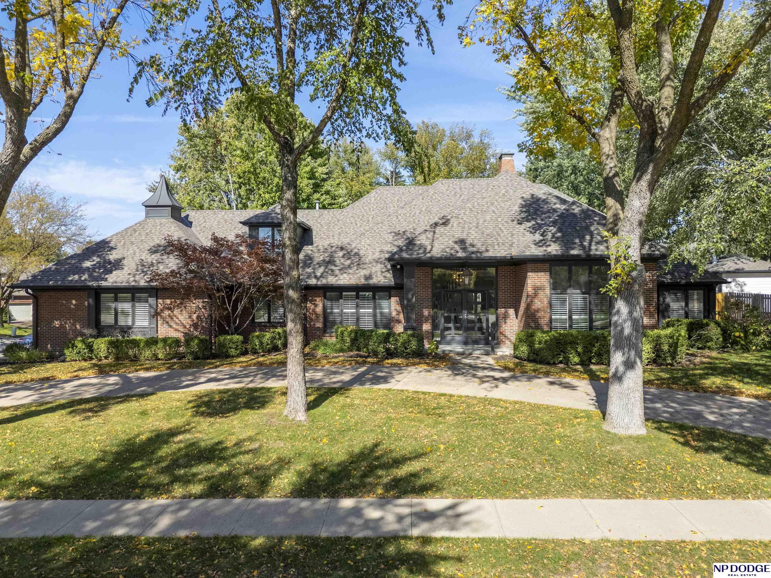 Stunning 1.5-story home in Linden Park situated on a .40 acre treed corner lot with circular driveway & true 4-car garage! A spacious entry and grand curved staircase welcome you into the home. Elegant formal living room with 12’ ceilings and spacious formal dining room; both with tons of natural light. The updated kitchen features brand-new appliances (gas cooktop), granite counters & refinished hardwood floors with informal dining. The large but cozy great room with fireplace & wet bar lead to the main-floor primary suite offering a luxurious bath with heated floors, spa-like shower, soaking tub and walk-in closet. Upstairs are three generous bedrooms & an updated full bath. The expanded lower level includes a large rec room with fireplace, wet bar, fifth bedroom, new bath complete with laundry hookup and plenty of storage. New roof & HVAC - 2022, new deck – 2025 and new interior paint 2025. Every detail has been beautifully updated—simply move in & enjoy!