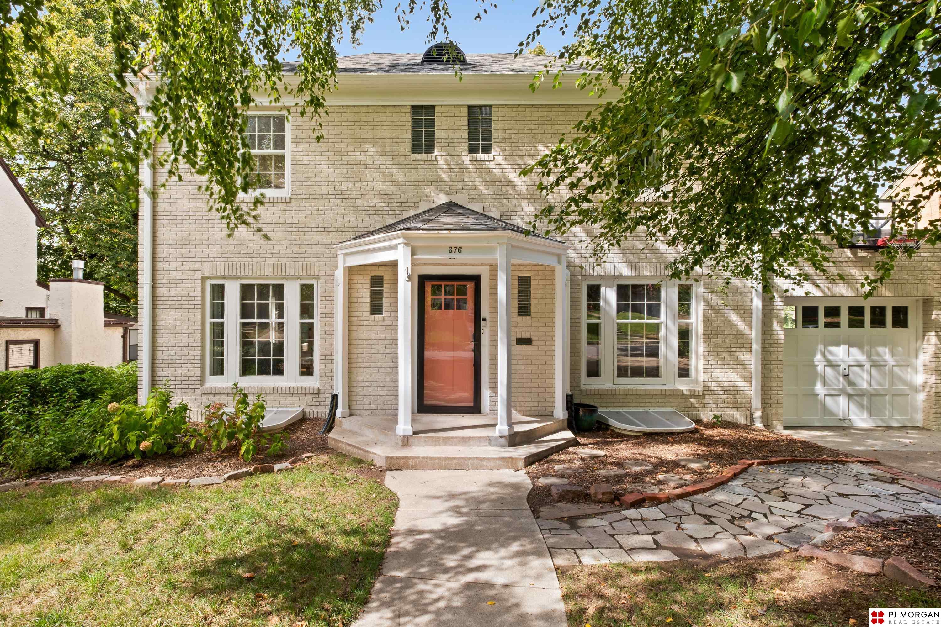 Classic Happy Hollow brick two story just half a block from Memorial Park and walking distance to Dundee! This home showcases original wood floors, untouched historic details, and warm character seamlessly blended with over $200,000 in thoughtful updates. The fully updated gourmet kitchen with Starmark cabinets opens to a large multi level deck overlooking the beautifully landscaped backyard, perfect for entertaining. Spacious bedrooms with large windows create inviting spaces, while the lower level offers a true 4th bedroom, entertainment space, and a bar with extra storage. Other big ticket updates include a new roof (2022), HVAC system (2024), and water heater (2024). Exterior freshly painted, well maintained, and full of pride of ownership. This home is ready for its next chapter in one of Omaha’s most sought after neighborhoods!