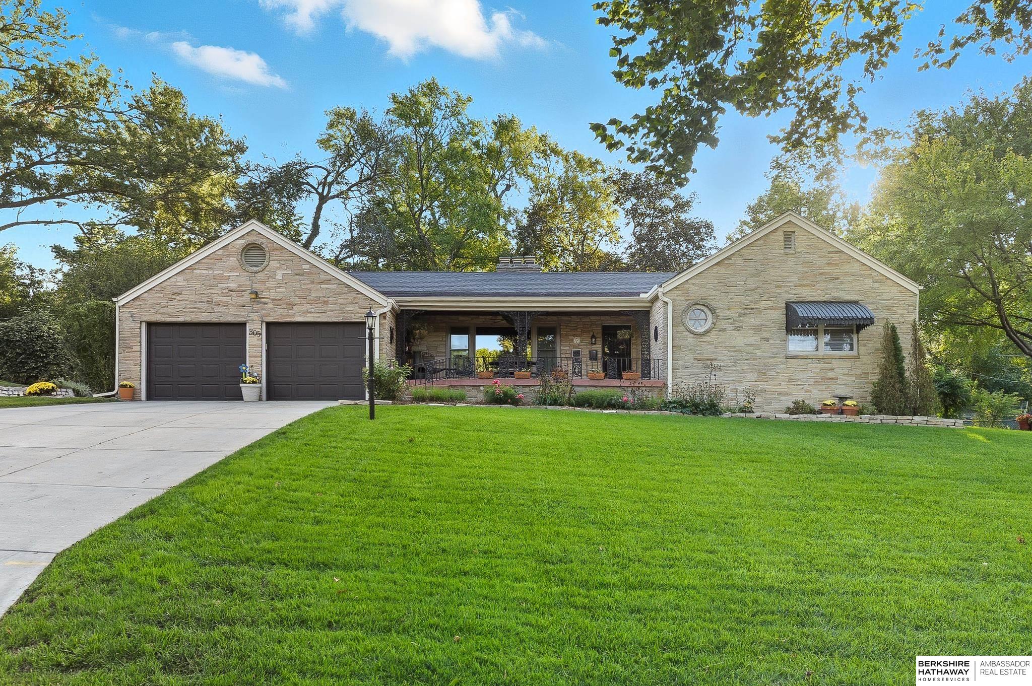 Beautiful Stone Ranch in the Heart of Omaha! Just west of UNO, near Elmwood and Memorial Parks! Built by Kiewit in 1951, this impeccably maintained 4-bedroom, 3-bath home features stunning Brazilian Koa hardwood floors throughout and brand new stainless kitchen appliances! Enjoy the natural stone landscaping, mature trees, and spacious yard with covered patio in front and additional patio in back. The kitchen and bathrooms are upgraded with quartz countertops and new cabinets. Updates include a 2019 roof with Class 4 impact-resistant shingles, new insulated garage doors, siding, and gutters. The lower level offers two bedrooms, a large living area, laundry, and plenty of storage. A perfect blend of comfort, charm, and location.