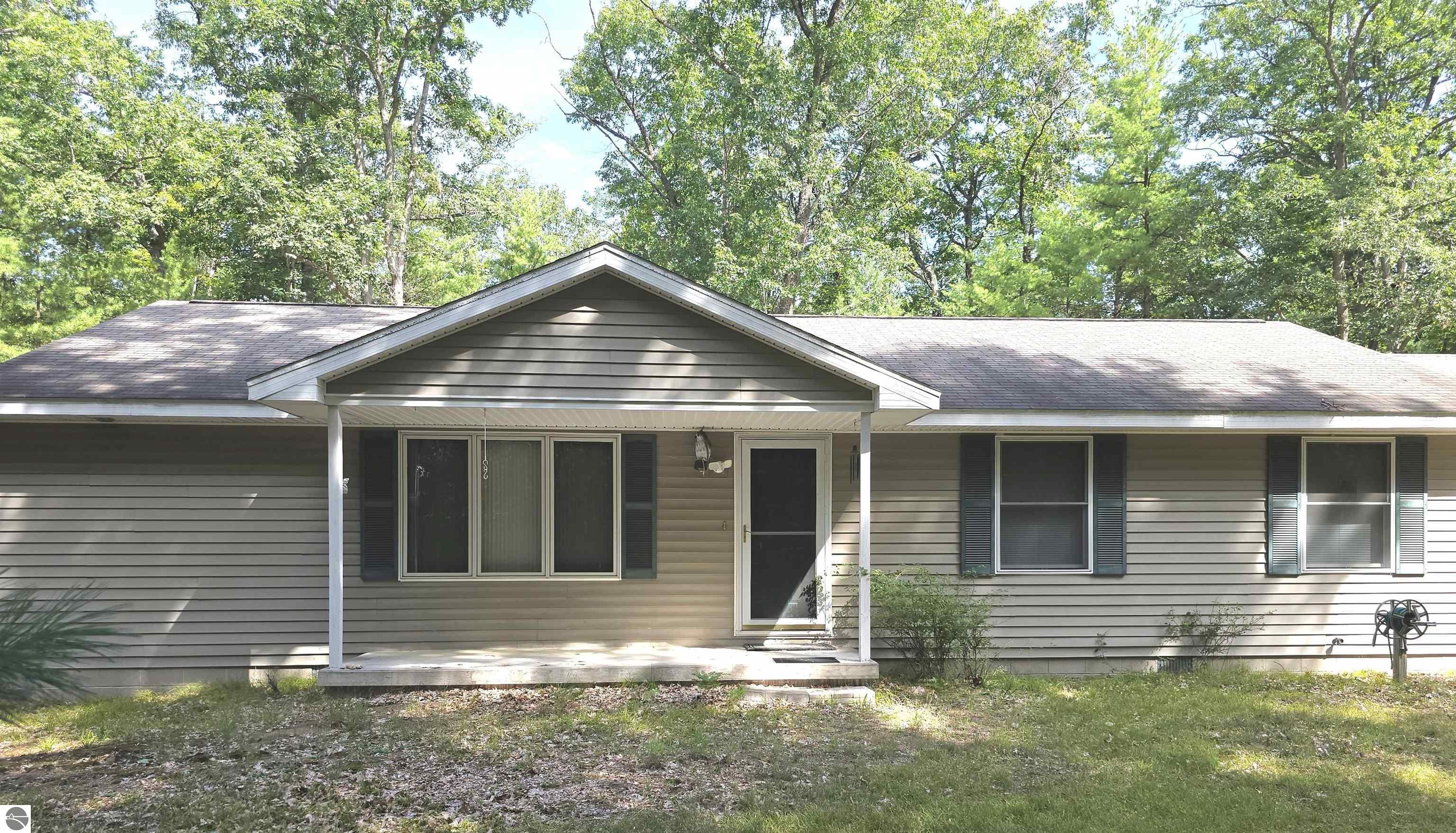 6576 W Plum Valley Road NW, Rapid City, MI 49676 — front exterior
