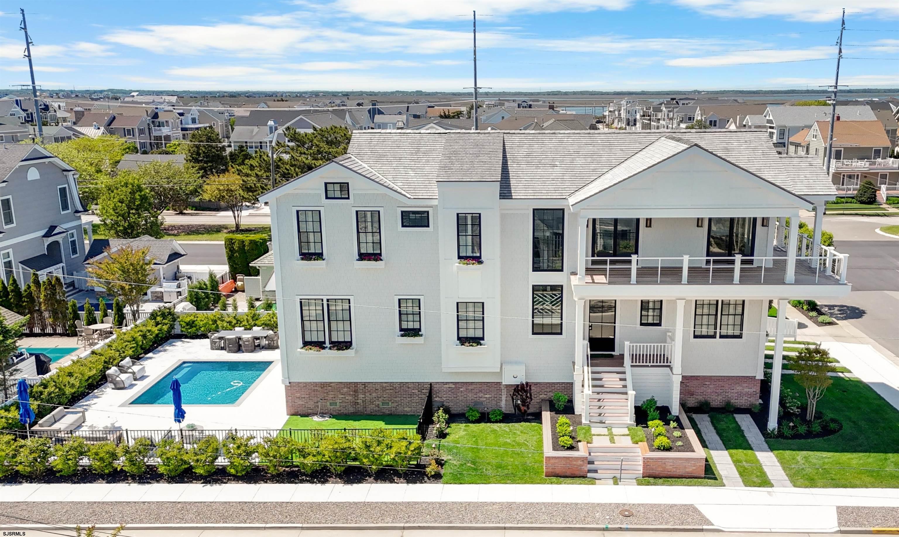 Fabulous corner location on coveted Pennsylvania Avenue, With expansive views down 86th Street to the ocean and some of the best beaches in the area this home is also situated close to the vibrant downtown Stone Harbor business district.  With 6 full bedrooms, 6 full ensuite baths and 2 half baths, this home will also feature natural stone and porcelain tiling, Thibault wall coverings, custom woodworking and trim, plantation shutters and motorized blinds.  Vaulted ceilings and oversized windows in the living, dining and kitchen areas on the second floor will allow natural light to pour inside and grace the exquisitely textured finishes throughout.  A separate family room on the first floor overlooks the expansive 2,000 SF pool area patio out back.  An outdoor kitchen and grille station will also allow for poolside entertaining after a relaxing day on the beach.  Other amenities include: Cedar shingle roof, Hardi-Shingle siding; Sub-Zero / Wolf Appliances, Finest quality flush inset cabinetry with 5/4" doors, Kohler plumbing fixtures, Wire brushed white oak engineered hardwood flooring throughout, Sonos A/V system, Oversized 14' x 22 gunite pool by Avalon Pools, Inc., 1,500 SF of area at 6 foot height in crawl space for storage; 580 SF of decks with views at second floor, Landscaping and Flower boxes by Garden Greenhouse and Nursery,  Fully furnished inside and out by Restoration Hardware.