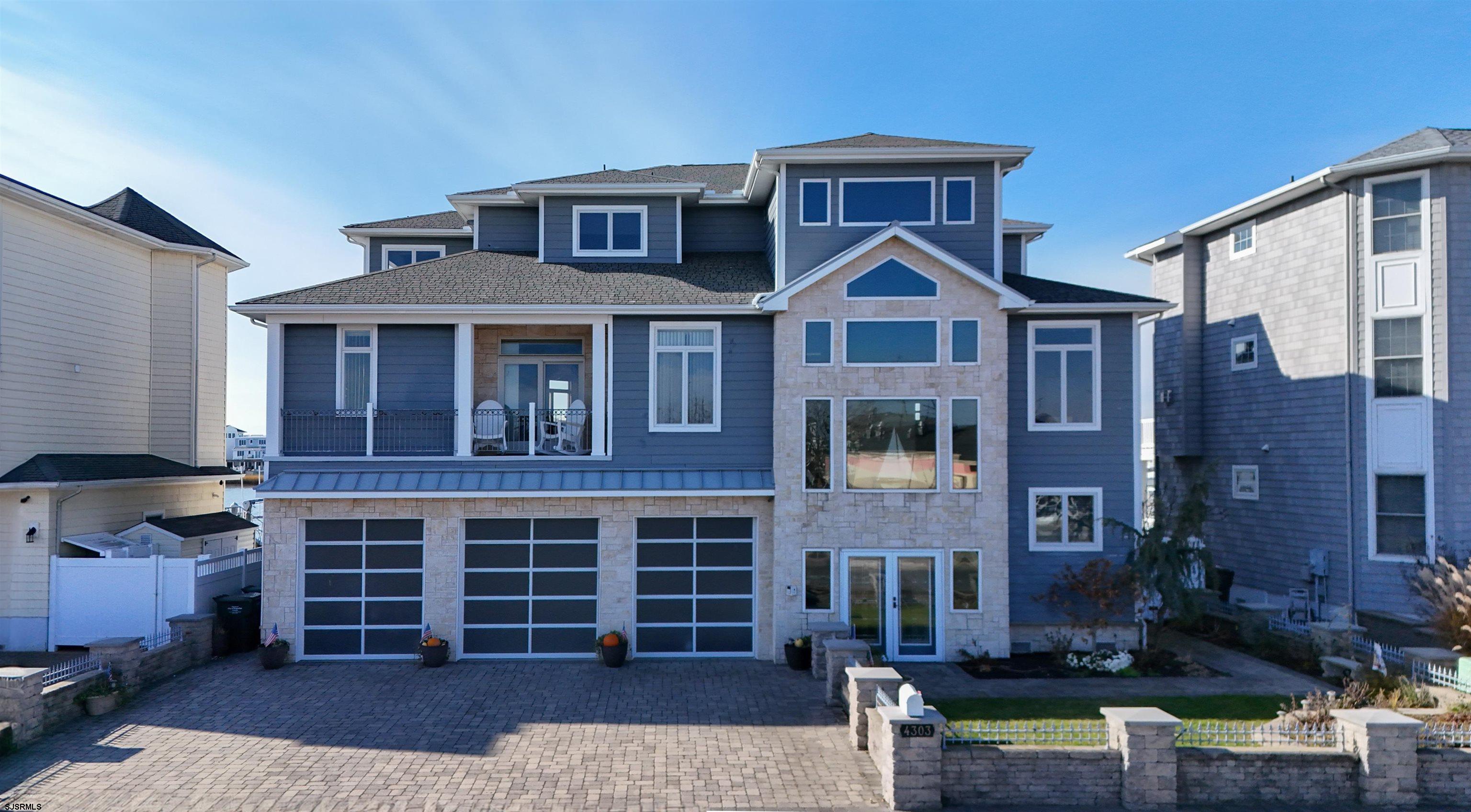 Experience waterfront luxury with this stunning custom-designed home, offering the perfect blend of elegance, comfort, and craftsmanship. Nestled on the water's edge, this exceptional residence boasts 4 spacious bedrooms, each with its own uniquely styled ensuite bath and a total of 5.1 impeccably designed bathrooms.  This home features a rare, true ground-floor elevator with no steps, providing seamless access to all levels and ensuring ultimate convenience for every lifestyle.  The entertainment level offers a huge open kitchen with unparalleled views of the water and the Atlantic City skyline. This space is perfect for hosting, blending functionality with breathtaking scenery.  On the top floor, soaring cathedral ceilings create an atmosphere of grandeur. The massive primary suite is a sanctuary, complete with a dual-sided fireplace that adds warmth to both the bedroom and the spa-like ensuite bath. The ensuite features luxurious finishes and a walk-in closet that redefines "impressive."  Every element of this home has been thoughtfully designed to provide a lifestyle of comfort and sophistication. From the custom finishes to the seamless integration of indoor and outdoor spaces, this property offers a unique opportunity to own a piece of waterfront paradise.  Step outside into your private oasis, where an inground pool takes center stage. The outdoor space is an entertainer's dream, featuring a fully equipped kitchen and a dock that caters to boating enthusiasts. The dock is fitted with water and electric hookups and includes two boat lifts, ensuring your vessels are always ready for the next adventure.  Additional Feature includes a spacious three-car garage with additional parking in the driveway, accommodating both residents and guests. The fenced-in front yard is perfect for your four-legged family members, providing a secure and welcoming space. Mutlizoned HVAC as well as multi-unit tankless instant hot water.   Schedule your private showing today to unveil all this home has to offer.