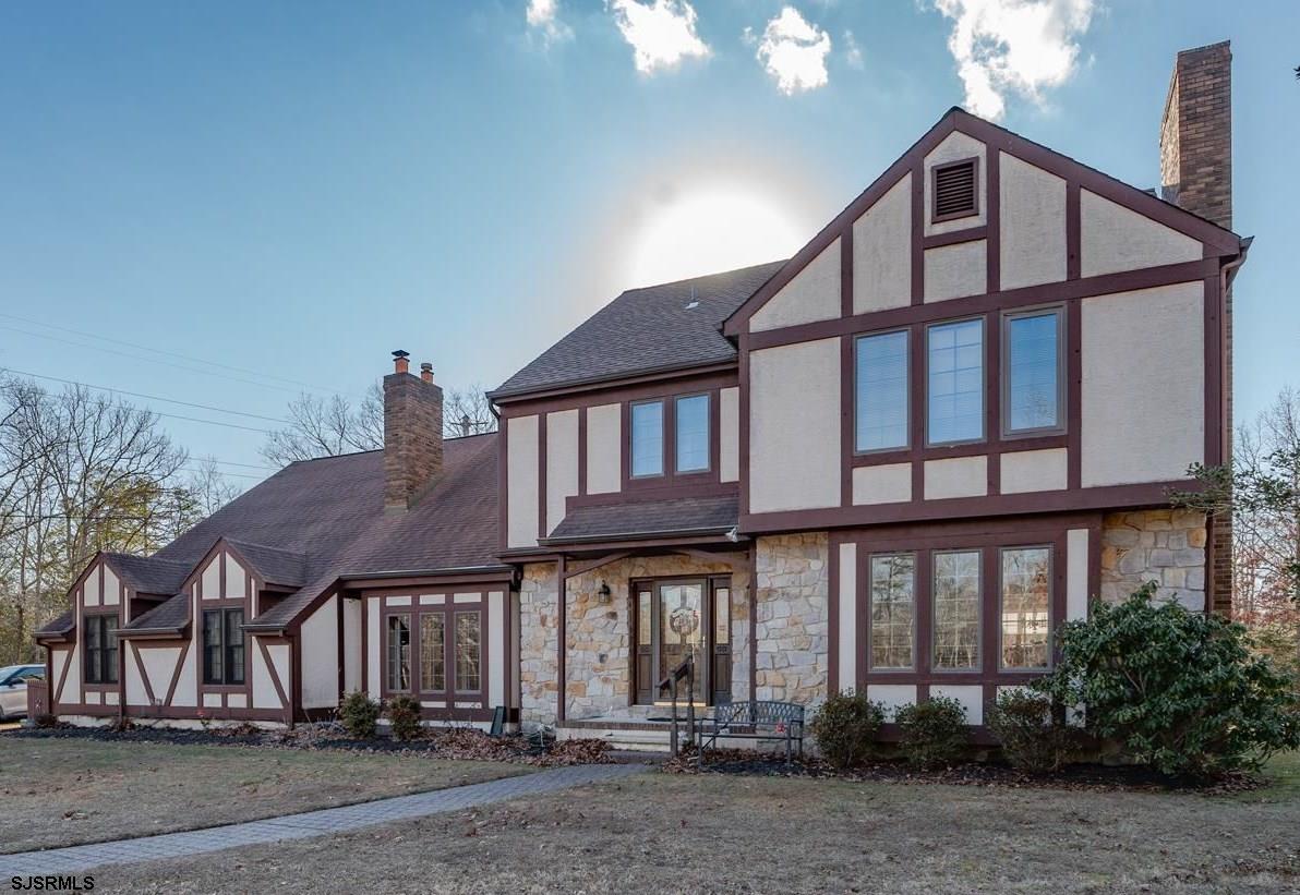 Welcome to a stunning custom-built estate set on a sprawling 3.2-acre retreat, offering the perfect blend of elegance, space, and modern convenience. Designed for multi-generational living, this extraordinary home boasts six bedrooms, 4.5 baths, and an abundance of thoughtfully designed living spaces. Step inside to discover a home built for both comfort and sophistication. The first-floor library, complete with a stately fireplace, invites you to relax with a good book or enjoy cozy evenings by the fire. The heart of the home—the gourmet kitchen—features gleaming granite countertops, newer appliances, and a seamlessly integrated built-in refrigerator that blends effortlessly with custom cabinetry. Just off the kitchen, a formal dining room sets the stage for elegant gatherings, while the four-season sunroom provides a serene space to enjoy the beauty of every season. The in-law suite, designed for privacy and convenience, offers three spacious bedrooms, a private living area, and direct access to its own deck—an ideal retreat for guests or extended family. Upstairs, the expansive master suite is a true sanctuary, complete with a spa-like en-suite bath and an oversized walk-in closet. Three additional generously sized bedrooms, along with a total of four full bathrooms and one half bath, ensure ample space and comfort for everyone. Outside, the estate continues to impress. Whether you’re cooling off in the above-ground pool, taking in the serene surroundings, or enjoying the energy efficiency of solar panels, this home offers both luxury and sustainability. This is more than a house—it’s an estate designed for those who desire space, style, and versatility. Don’t miss your chance to make it yours—schedule a private showing today!
