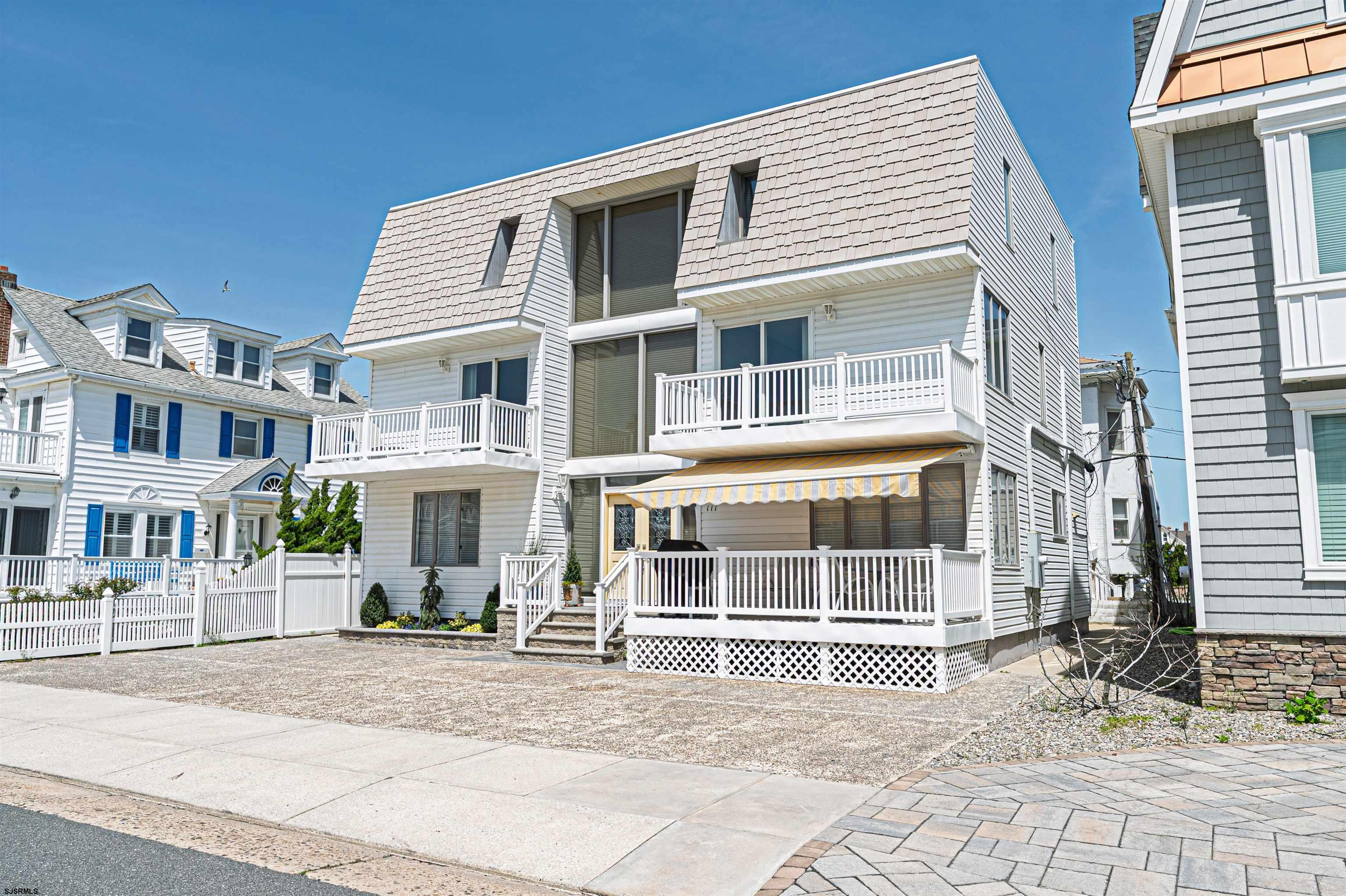 This stunning, one-of-a-kind Ventnor home offers 6 bedrooms, 4.5 baths, and breathtaking boardwalk and ocean views from two expansive second-floor decks. Just three houses from the beach and boardwalk, it’s also within walking distance to restaurants, shops, and a short stroll to Margate. With a driveway that accommodates five cars, convenience is unmatched.  The first floor welcomes you with a spacious front porch, perfect for enjoying the ocean breeze. Inside, you'll find a generous living room with a gas fireplace, a versatile dining area/den/gaming space, and a formal dining room that flows seamlessly into a beautiful, oversized kitchen featuring an extra-wide Sub-Zero refrigerator. A powder room and laundry room complete this level.  The second floor boasts two large identical primary suites, each with private access to their own second-floor deck, where you can take in spectacular ocean views.  The third floor offers four additional spacious bedrooms and two large bathrooms, providing ample space for family and guests.  Completing the home are two sheds, perfect for storing all your beach toys and bikes.  Designed to accommodate two families, this home is ideal for multigenerational living or a luxurious vacation retreat with plenty of room for everyone. Most of the home has been updated within the last 12 years.  Don’t miss this incredible opportunity—beach block living at this price won’t last long!