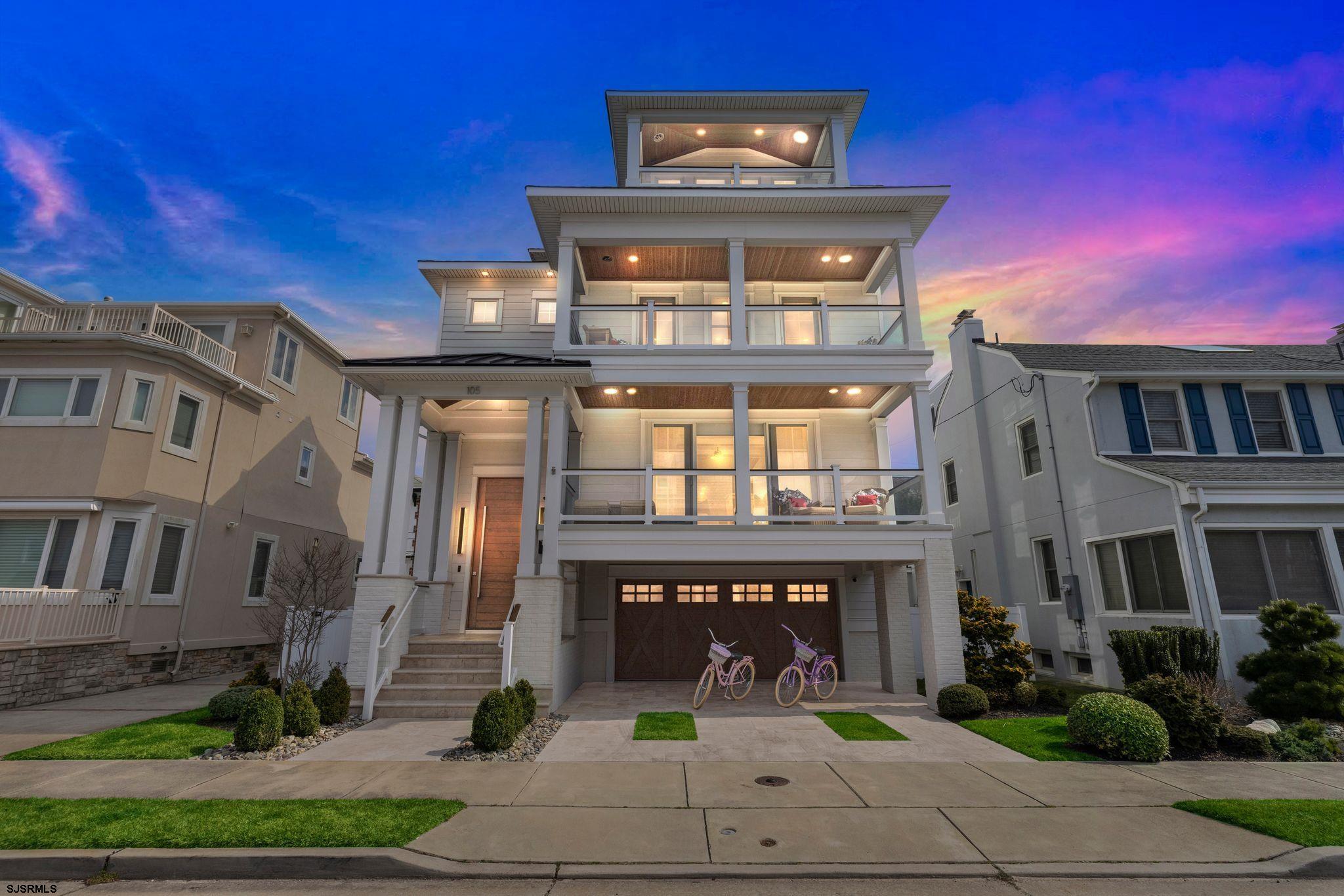 Experience the pinnacle of beachside elegance in this custom-built Margate home, crafted in 2019 with designer finishes throughout. Perfectly positioned just steps from the beach, this stunning residence sits on one of the area’s most sought-after streets, just two blocks from both the boardwalk and the island’s best restaurants and cafés. From the moment you arrive, the home’s gorgeous Mahogany exterior accents and grand entrance set the stage for refined coastal living. Step inside to a soaring two-story foyer, or enter through the oversized garage, which features a four-stop elevator for added convenience. The main living area boasts an open-concept design with 9-foot coffered ceilings, a cozy gas fireplace, and wide plank wood floors. Sliding glass doors lead to an expansive deck with breathtaking ocean views, perfect for morning coffee or evening cocktails. The chef’s kitchen is a culinary masterpiece, outfitted with custom cabinetry, premium Wolf and SubZero appliances, a large center island, and a separate wet bar. A chic powder room and a stylish laundry room with custom cabinetry complete this level. On the second floor, you’ll find four spacious bedrooms and three full baths, including two junior suites with direct access to the second-floor deck. A second laundry area provides added convenience. The third level is dedicated to the ultimate primary suite, a true retreat featuring panoramic ocean views, soaring vaulted ceilings, a spa-like ensuite, an oversized walk-in closet, and a private deck. Outdoor living is just as impressive, with a large tiled outdoor shower, a spacious fenced yard, and multiple decks designed for relaxation and entertaining. Offered fully furnished with high-end designer touches throughout, this home is truly turnkey—just bring your suitcase and start living the Margate lifestyle. Don’t miss this rare opportunity to own a one-of-a-kind coastal sanctuary. Schedule your private showing today! Take a virtual tour here: https://vimeo.com/925834715