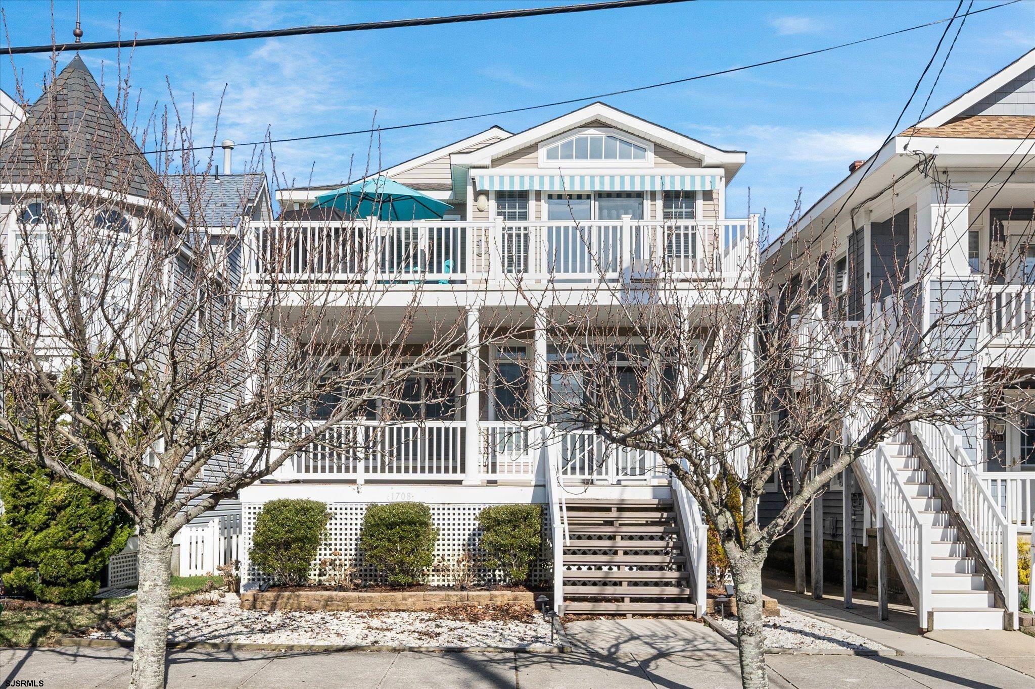 Stunning, Fully Updated 4-Bedroom, 2 Bath Condo along the Goldcoast in Ocean City! This beautifully renovated condo offers modern elegance and coastal charm in an unbeatable location at 17th & Wesley—just steps from the Beach. Featuring an open-concept layout, the spacious living and dining areas seamlessly blend style and comfort. The designer kitchen boasts a large center island with seating, quartz countertops, a stylish tile backsplash, stainless steel appliances, and custom cabinetry. The vaulted-ceiling living area is enhanced by a built-in gas fireplace, shiplap wall detailing, and two sets of sliding glass doors leading to the front porch. The primary suite is spacious, offering a walk-in closet, private access to the rear porch, and a luxurious en suite bathroom with a double vanity and oversized walk-in shower. Three additional bedrooms provide ample space for family and guests, and a full hallway bath and laundry closet.  Additional features include beautiful hardwood floors throughout, multiple outdoor porches including private roof top deck w/ Ocean views, an enclosed outdoor shower, an attached garage, and extra storage. Don’t miss this incredible opportunity to own a piece of paradise—Easy to Show!  Call Today!