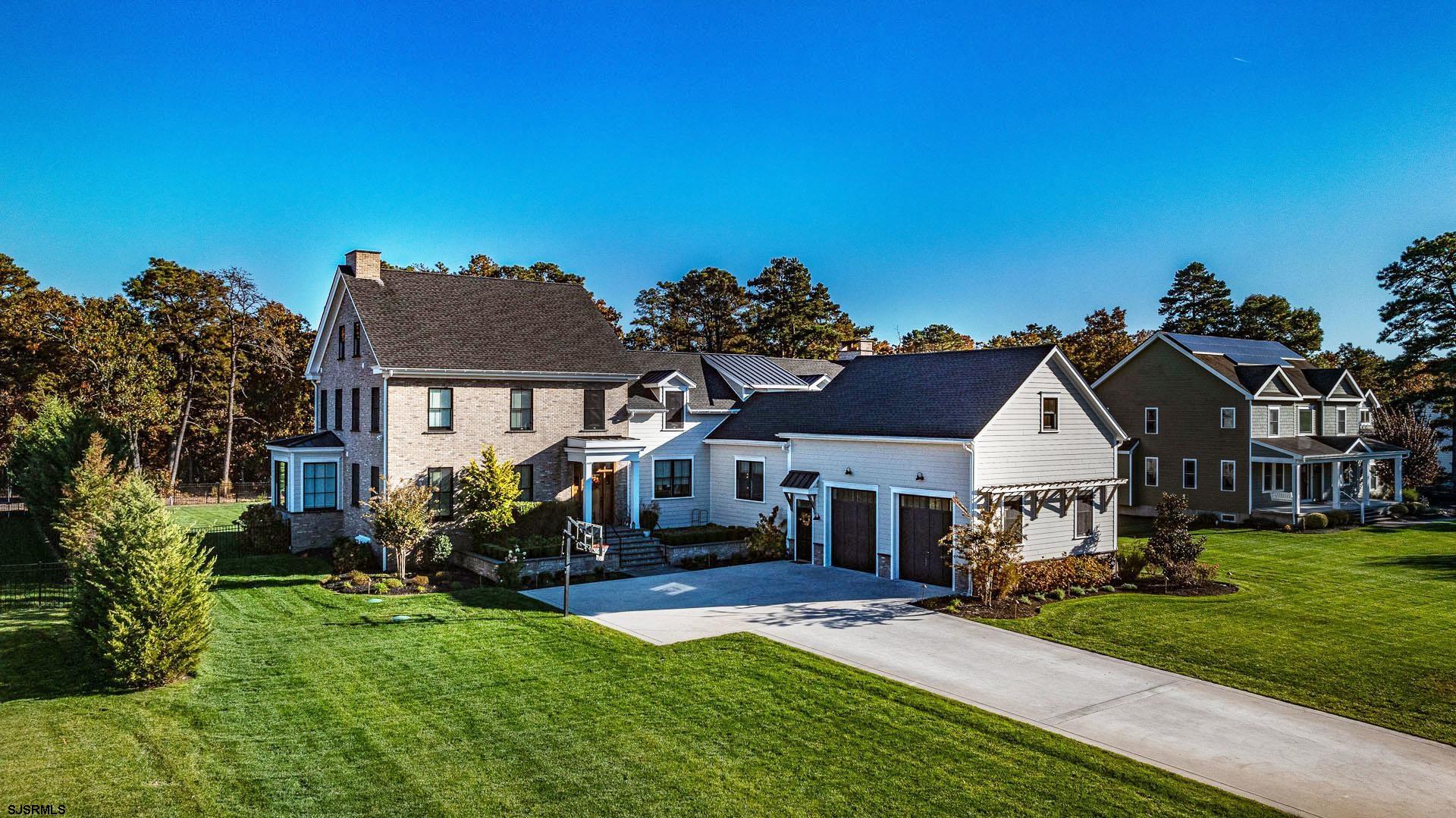 Embrace yourself in luxury with this breathtaking estate. From the moment you arrive at the property you will take notice of its rich curb appeal, as you proceed to the front door you are welcomed by an elegant, raised brick entrance and a custom-made front door. Once inside you are surrounded by the most luxurious finishes including a custom floor to ceiling trim package, rich wide plank hardwood floors, gourmet chef's kitchen with quartz counter tops and much more. The first floor offers an expansive floor plan which includes a breathtaking living room with double height cathedral ceilings and a large wood burning gas fireplace, a large dining room which opens to the kitchen and overlooks the backyard office, full hall bathroom, 2nd laundry room and a tranquil master suite. The second floor is appointed with 4 additional bedrooms, 2 full bathrooms as well as an additional laundry room. This incredible home also offers an enormous five star fully finished basement with a kitchenette bar area, full bathroom, office, living area and a movie theater.  The exterior equally is as impressive as the interior, second to none and embraces luxury at every turn with a large front and rear yard, huge 2 car + garage, marble patio, screened in porch and custom gunite pool.