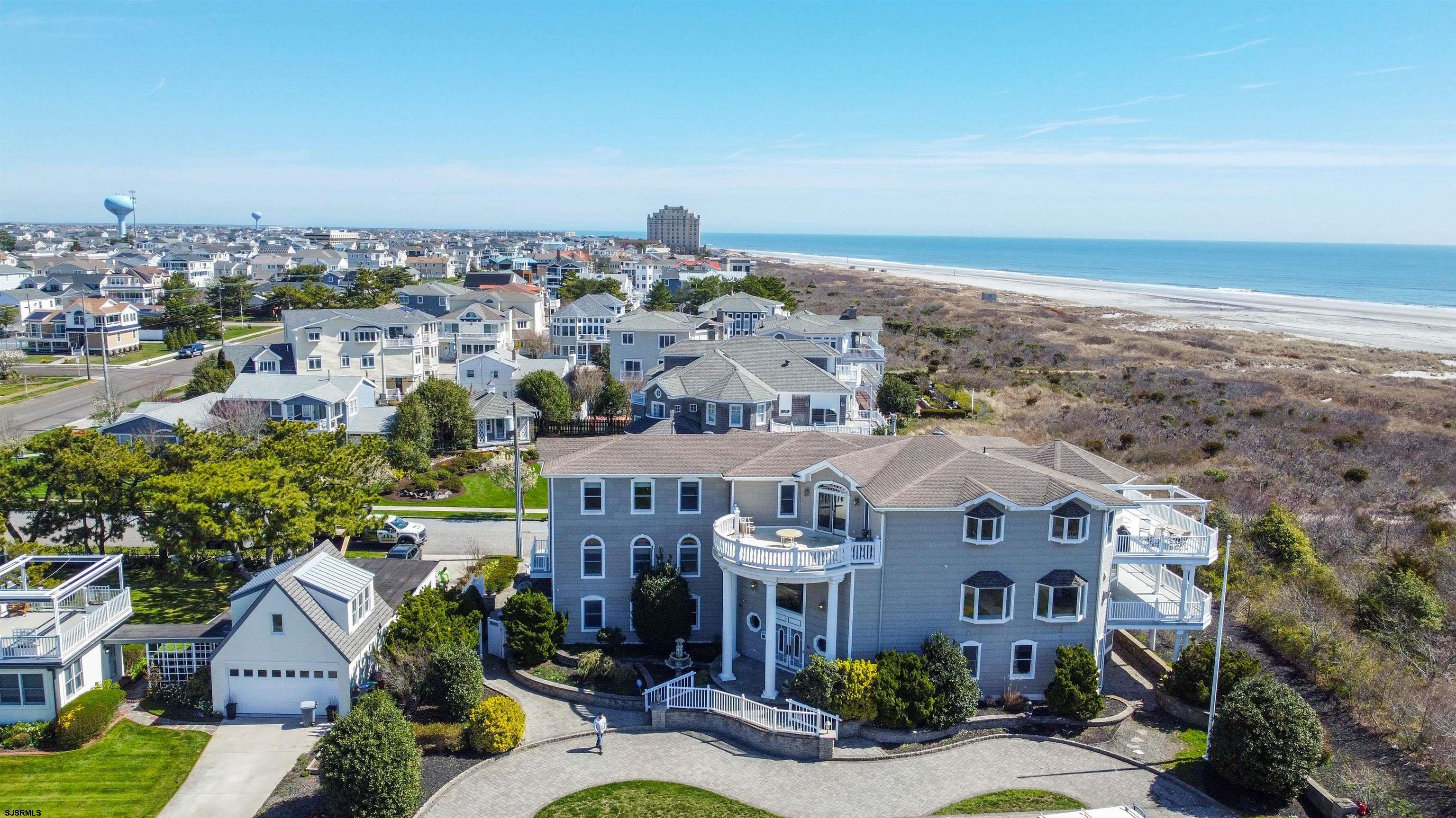 Amazing Location! Direct Oceanfront with Breathtaking Seascapes! This impressive home will allow you to entertain on a Grand Scale, featuring over 10,000 sq ft of living space plus a 2-car garage on a 130 x 93 lot! This Coastal retreat is located in the heart of Brigantine's A-Zone. 2 Entertainment Rooms, a Chef's Kitchen, a massive Primary Suite! Custom designed and elegantly appointed every room unique but cohesive throughout the home. Third floor reverse living features an open floor plan with the main living room, dining room, Chef's kitchen, pantry, family (TV) room and with a Bar/ Gameroom. The primary suite is an oasis where you can awake to the calming sounds of the waves with unobstructed beach and ocean views, a spacious covered deck, walk-in closet and a luxurious bathroom. There are 3 junior suites that all have private sitting areas that can also be used as bedrooms. The home has been freshly painted, new carpets and is being sold partially furnished. There are 2 laundry rooms, 5 HVAC systems, 4 gas fireplaces, 5 decks, large closets, a 2-car garage, two outside showers, and plenty off street parking front and back of the home. Walking distance to restaurants, shopping and parks. This is truly a One-of-a-kind Beach Front Location! Call for more information and to schedule your private tour today! (Virtual staging was added and the furniture is not included)