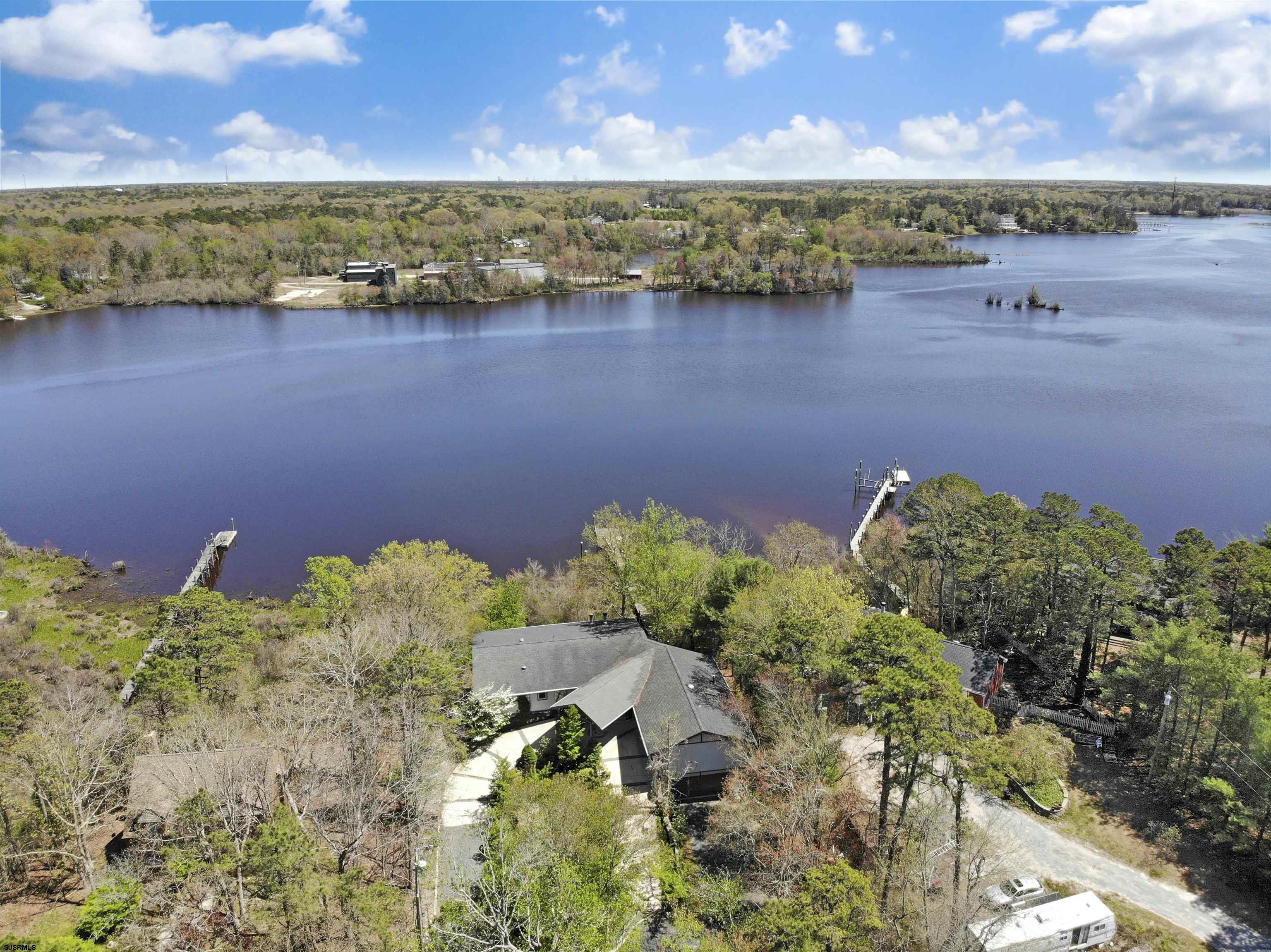 Water front living on the beautiful Great Egg Harbor River, this fantastically maintained custom-built home will truly take your breath away. Park in your covered-front entrance and step into your personal paradise. This expansive home features sweeping views of the river upon entrance, and throughout the home. The recently-updated chef's kitchen boasts newer stainless-steel appliances, a farmhouse style sink, and a spacious butler's pantry. Outside the home lush gardens surround you, and custom stonework patios and terraces offer endless potential for outdoor entertaining. Nothing can compare to the views of the sunrise and sunset from your own personal dock. Flooding is of no concern in this home, as it is not situated in a federal flood zone since it is built upon high ground.   The only way to truly experience the majesty of this incredible home is to schedule a showing today!