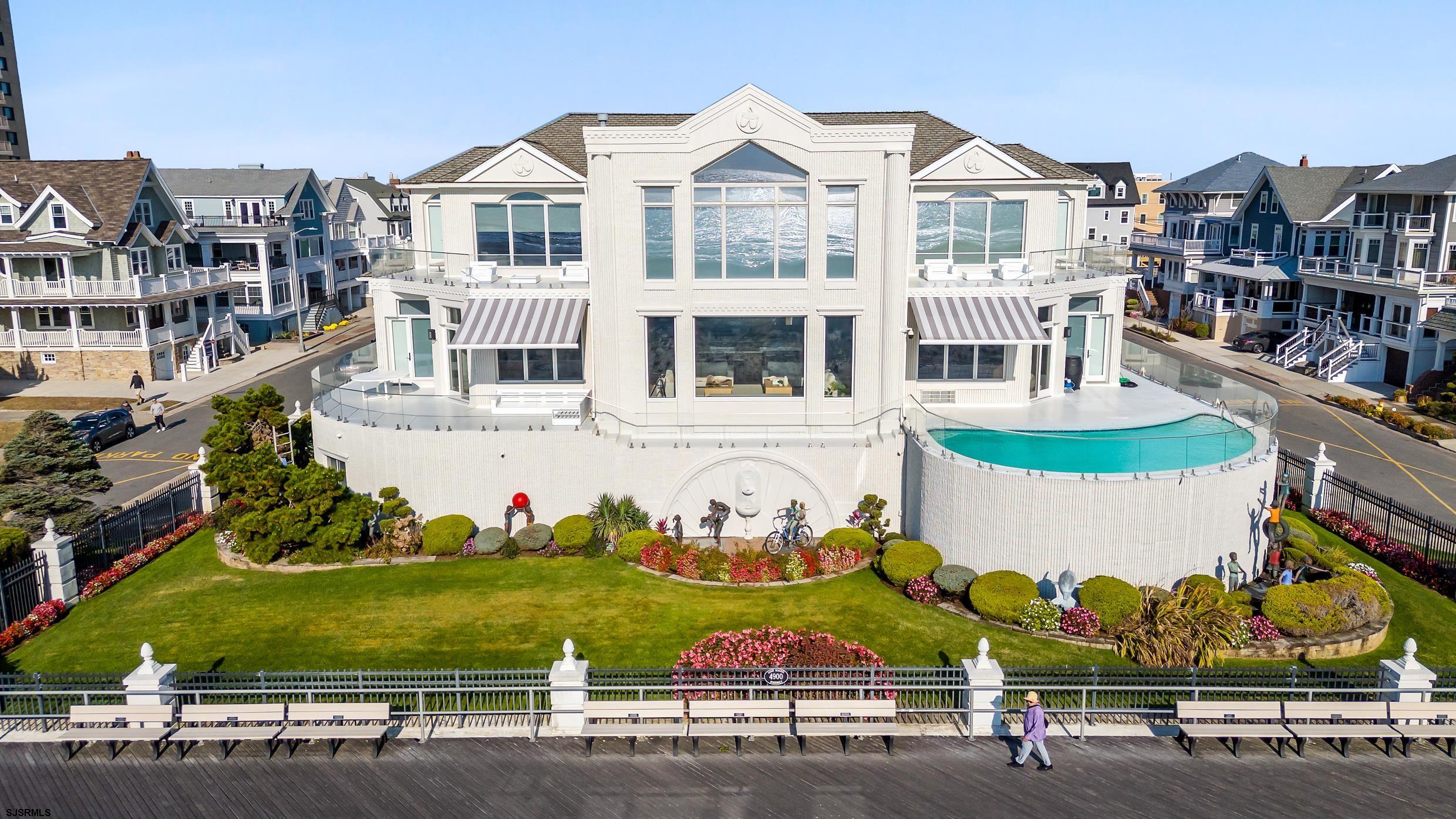 4900 Boardwalk is a landmark property on Absecon Island at the Jersey Shore, steeped in history. This custom, dream estate, set on 125 feet of direct ocean frontage, boasts over 10,000 square feet of unparalleled elegance, stretching from block to block. Finished with modern sophistication, quality craftsmanship, and thoughtful design, it offers a seamless blend of grand entertainment spaces and tranquil areas for private retreat.  With 15 spacious bedrooms, each featuring en suite baths, and 16.5 bathrooms adorned with luxurious fixtures, comfort and privacy are at the forefront of this residence. A gated entrance provides security and seclusion, while a service kitchen adjacent to the main kitchen makes hosting large gatherings effortless. The second-floor pool, offering unobstructed panoramic views of the Atlantic, invites you to relax and enjoy the ocean breeze. Car enthusiasts will appreciate the 6+ car garage and expansive driveway, and the large game room ensures fun for all ages.  Additional amenities include a gym and sauna for wellness, an elevator providing easy access to all levels, and a state-of-the-art smart home system for enhanced convenience. With an impressive 125x125 lot size, the grounds offer ample outdoor space for recreation or future development. This is a rare opportunity to experience the epitome of luxury coastal living in an exclusive and breathtaking oceanfront setting.