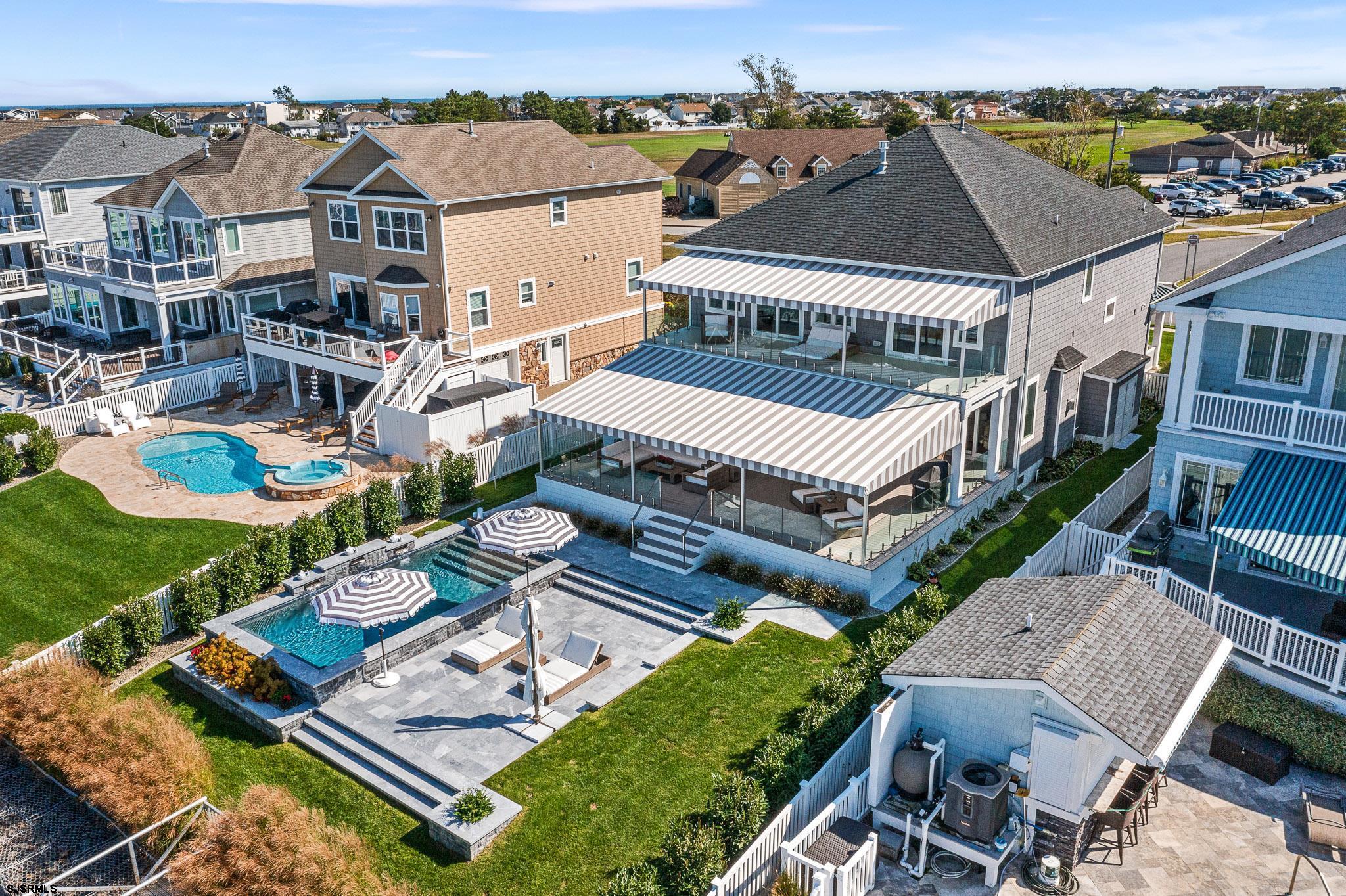 Calling all boaters a must see dream home on the BAY, complete with new luxurious custom gunite heated salt water in-ground POOL, nestled on desirable Golf Course Drive in Brigantine! No expenses spared in this 5 bedroom 3.5 bathroom home that shows like new construction. Two Master Suites with one located on the first floor, perfect for guests and/or a large family. Gorgeous & contemporary interior with a neutral, soothing color palate that boasts so many fine details throughout. Entertain proudly in the spacious gourmet kitchen built for a chef complete with Monogram oven, Viking range , Bosch appliances and large center island with counter seating. Living room is open and spacious with a cozy fireplace and  surround sound. Unwind out back on the expansive deck/patio which overlooks the pool and the AMAZING Bay Sunsets & views! The backyard is it's own paradise oasis . Newer Awning covered decks & ceiling fans make it a pleasure to relax there in the warmer months,  enjoy the pool with soothing waterfalls , not to mention your very own DOCK & BOATLIFT that holds up to 16,000 lbs ! The breathtaking bay and sunset views can be seen from numerous rooms from within the home as well. So much to love in this bayfront home! CAFRA approved for an additional boat lift. Property located in the X-Zone , flood insurance not required per FEMA for this high and dry location. Gabion retaining wall life span up to 100yrs. House Generator , enclosed outdoor shower, under deck storage, and two car garage. Call to schedule your private tour today !