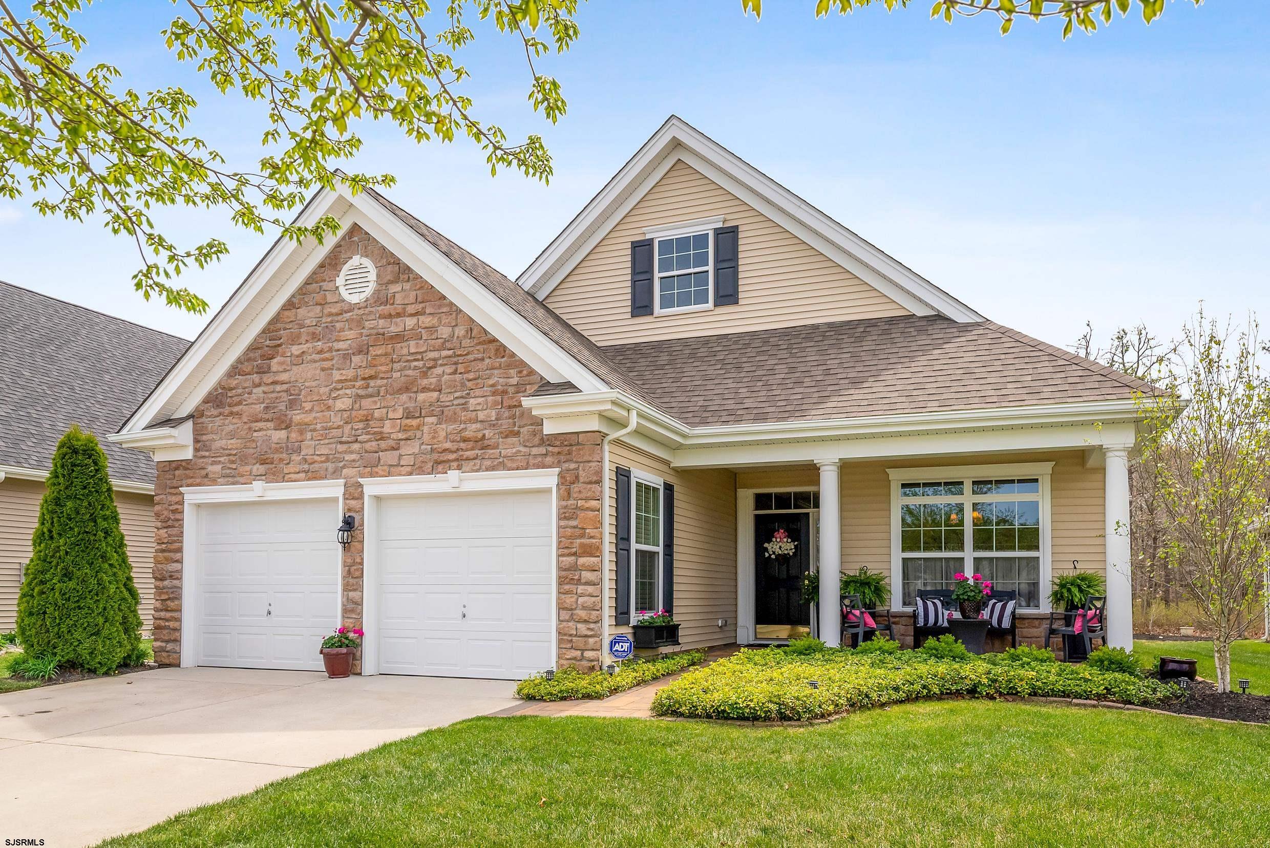 Welcome to this PROFESSIONALLY designed home in the newest section of The Village Grand at English Mill, Egg Harbor Township! This STUNNING 2-bedroom, 2-bath ranch-style gem boasts an array of CUSTOM upgrades and MODERN elegance. Head inside to discover wide plank, hand-scraped wood floors in the main living areas complemented by new carpet in the bedrooms. The INVITING foyer, adorned with wainscoting, sets the tone for the thoughtful CRAFTSMANSHIP throughout. The heart of the home is the GOURMET kitchen, featuring granite countertops, 48" tall cabinets, a custom glass tile backsplash, and stainless steel GE Profile appliances, including a counter-depth refrigerator. Enjoy casual meals at the breakfast peninsula with stools or in the bright breakfast room. The SPACIOUS living room, warmed by a custom-built stone fireplace, is perfect for cozy evenings. Retreat to the primary bedroom, complete with a walk-in California Closets for ultimate organization. The VERSATILE den, with French doors, offers flexibility as a potential 3rd bedroom (with a queen-size sleeper sofa!) or home office. Outside, the extended paver back patio, custom pergola, and METICULOUSLY designed planters create a serene OASIS, enhanced by a dozen added evergreens and pines for year-round privacy. The front walk and porch, also finished with pavers, add curb APPEAL. A 2-car attached garage provides ample STORAGE and convenience. Jam-packed with UPGRADES, this home leaves nothing to be desired. From the custom California Closets to the professionally landscaped grounds, every detail has been carefully curated. Perfectly situated in a prime Egg Harbor Township location, this move-in-ready masterpiece is ready to welcome you home. INCREDIBLE Adult Community with FANTASTIC amenities such as a clubhouse, outdoor POOL, tennis, and pickleball courts. PERFECTLY situated near Garden State Parkway, casinos, premier golf courses, Renault Winery, BEACHES, and Storybook Land!