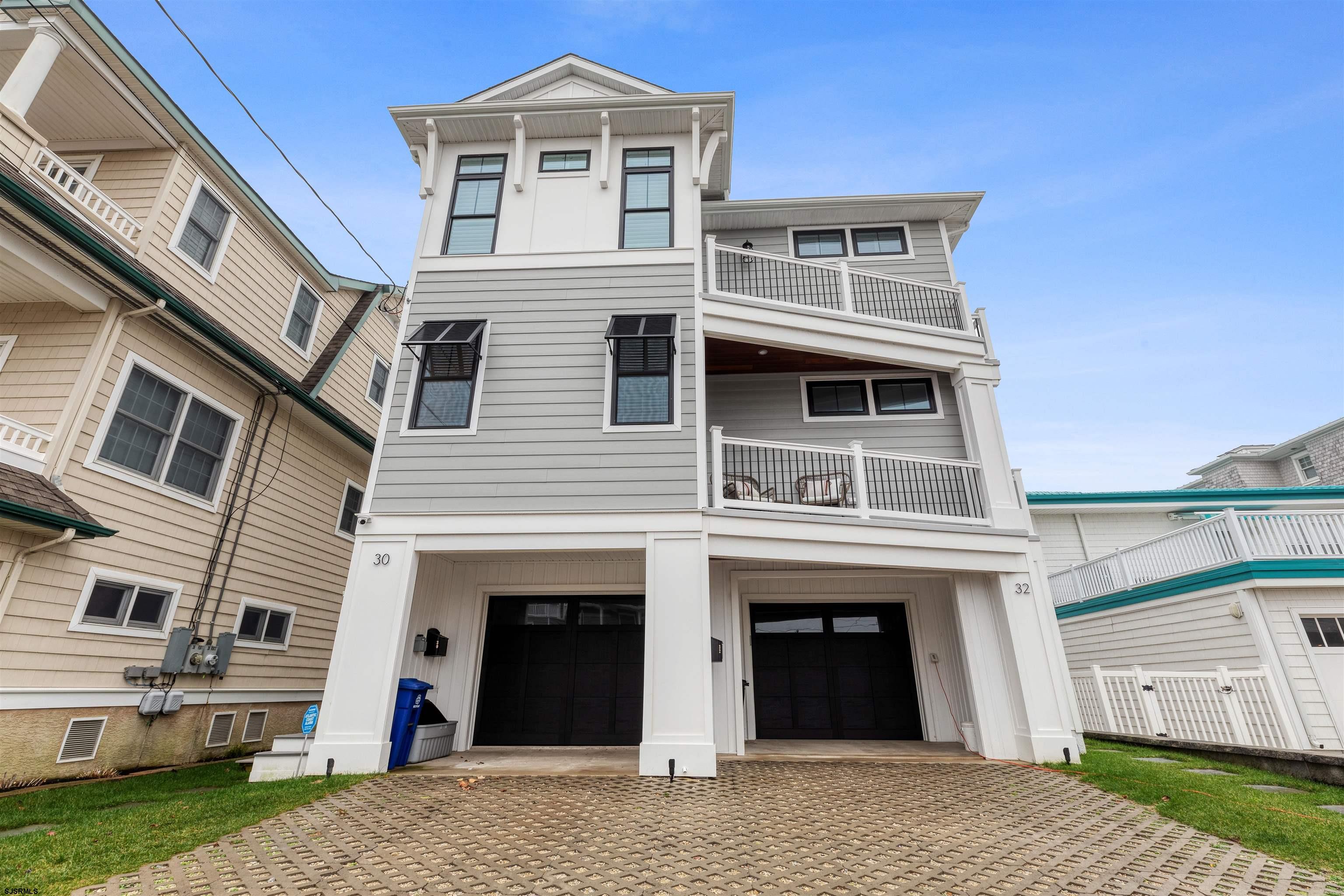 Coastal Elegance Meets Waterfront Living in the Heart of Snug Harbor  Welcome to 30 W 8th Street — a stunning, designer-furnished bayfront residence offering a rare blend of luxury, comfort, and captivating views. Perfectly positioned on the tranquil Snug Harbor Lagoon, this immaculate 1st-floor condo delivers panoramic open bay vistas, nightly sunsets, and front-row views of the iconic 9th Street Bridge.  This spacious, thoughtfully designed home features 4 bedrooms plus a versatile den or bonus room, and 3 full bathrooms, all crafted with elevated finishes and attention to detail. The main living space flows effortlessly from the chef’s kitchen, outfitted with white shaker cabinetry, granite countertops, and premium Wolf and Kitchen-Aid appliances, to the sun-drenched dining area and cozy living room complete with a gas fireplace, custom millwork, and sliding glass doors leading to the waterfront porch.  Step outside and embrace true outdoor living with a private boat slip equipped with an electric lift, a lush rear lawn, and a ground-level patio that’s perfect for entertaining or unwinding after a day on the water. Additional features include central air, gas heat, an outdoor shower, a stylish cabana space, and ample parking in the attached garage and driveway.  Professionally curated and sold mostly furnished with designer pieces and tasteful appointments, this home is move-in ready and brimming with elegance and ease. Whether you're looking for a year-round residence, second home, or luxury retreat, this bayfront beauty checks every box.  Waterfront homes of this caliber are rare — don’t miss your opportunity to own a slice of paradise in Ocean City’s most coveted lagoon-front location.