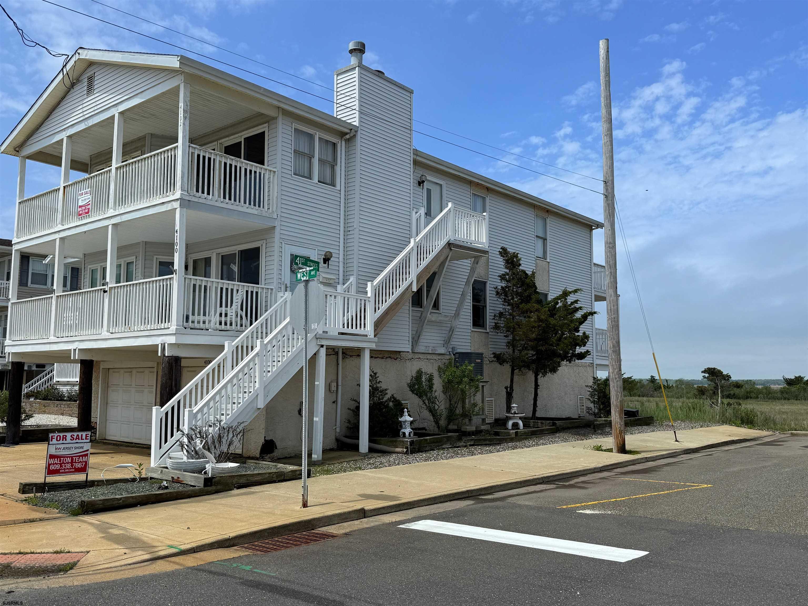 Wide open, unobstructed views of sunsets, wetlands and wildlife. Oversized corner 40 x 100 lot with plenty of parking. 5 homes from the beach.  Roomy 3 bedroom, 2 bath property with large front and rear decks, 50 year, GAF-certified roof installed 2024, exterior stairs replaced 2023. Vaulted ceilings, garage, storage and outside shower. Just needs your personal touches. It's all about the captivating views at 4102 West Ave.