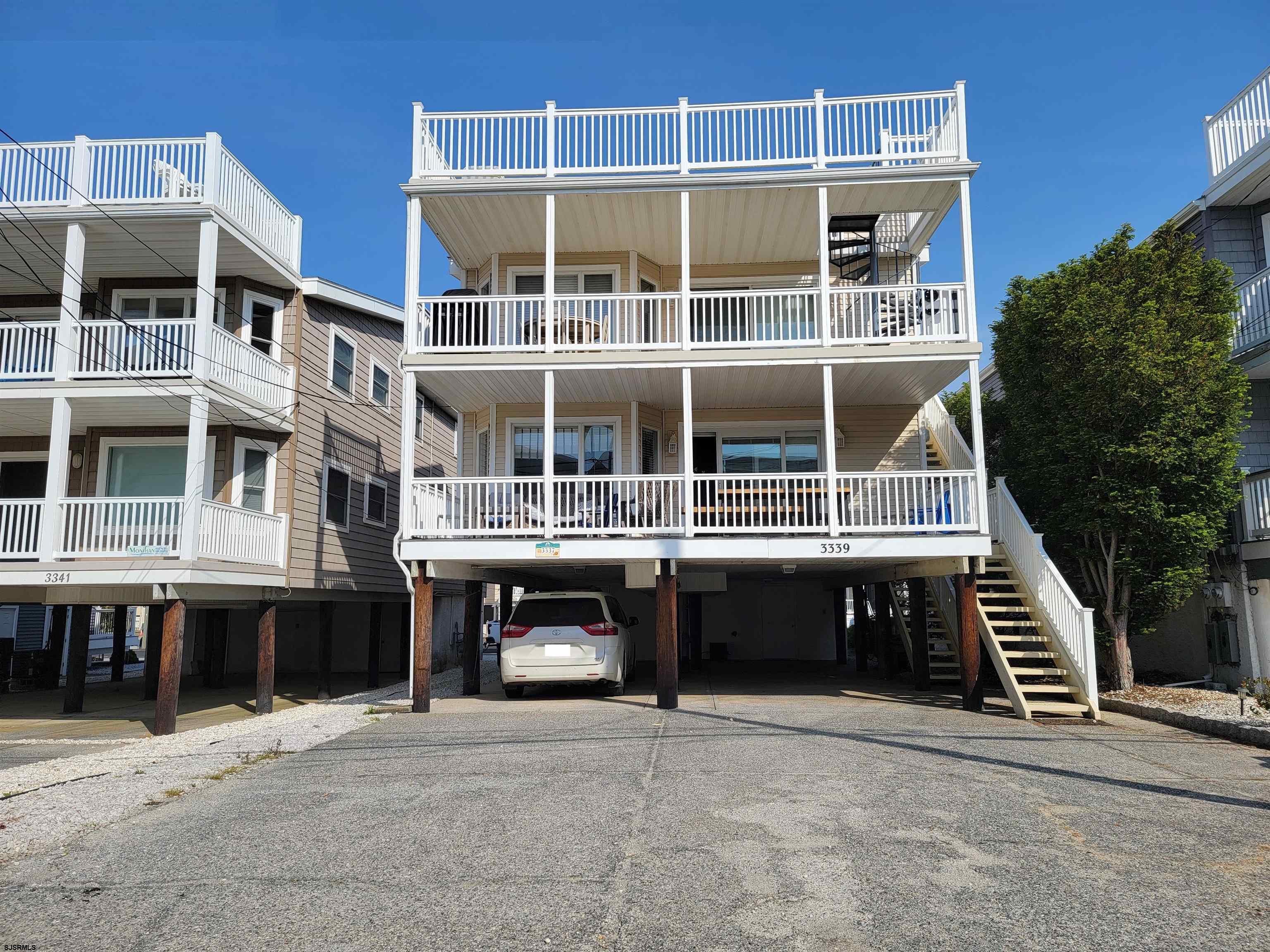 Almost Beachfront!  Location, location, location!! Check out this first floor home that sits just one house off of the beach! You can enjoy the ocean breezes, the salt air and sounds of the waves from your large east facing porch or living room - for a fraction of the price of beachfront! This four bedroom, 2 bath home is conveniently located near the 34th Street beach with easy access to the bridge, restaurants, Wawa, Acme, mini golf, and ice cream shops. It offers a newer kitchen with white cabinets, a spacious dining area (also easterly facing), granite counters and tile flooring, four brand new twin beds, a gas fireplace, plenty of off-street parking, and weekly summer rentals already in place.  Start collecting income as soon as you buy it with over $54,000 (gross) in rental income booked for this summer. This is the most attractively priced beachblock property you'll find in Ocean City!  Don't miss it!