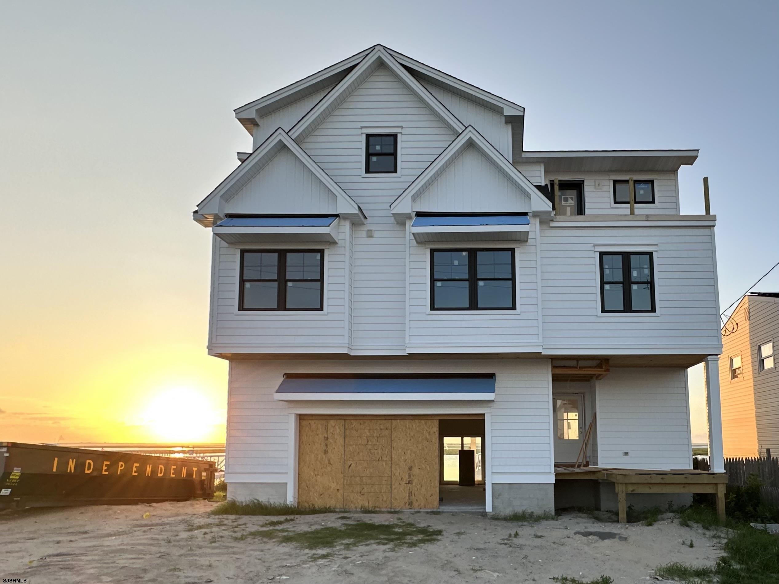 **Experience Luxurious Bayfront Living!**  **Custom New Home with Elevator, Bulkhead, Dock, and Boat Lift—All For UNDER $2 Million!**  Dock and Boat Lift installation complete !! Property Sheet Rocked !! Still time to choose some of the finishes !! Could Be AHEAD of SCHEDULE !!!****  Step into your dream with this exquisite new coastal bayfront home, featuring a reverse open floor plan that maximizes stunning views and natural light. Enjoy the elegance of vaulted ceilings, a gourmet kitchen adorned with chic shaker cabinets, and beautiful quartz countertops that complement the oversized island, perfect for memorable family gatherings. The spacious family room seamlessly flows to an expansive outdoor deck, where breathtaking views await- ideal for morning coffee or evening sunsets. This home boasts two luxurious master bedroom ensuites, providing ample space, privacy and comfort for you and your guests.   Imagine waking up to picturesque vistas from both the front and back of your home, capturing the essence of the Brigantine lifestyle you’ve always desired. Spend your days indulging in boating, fishing, and thrilling water sports, then return to relax on your beautiful decks as the sun dips below the horizon, painting the sky with vibrant colors.  The best part? You still have the opportunity to choose your finishes! With an estimated  October 2025 delivery and model homes available for touring, this is your chance to create the bayfront sanctuary you’ve always dreamed of. Don’t let it slip away!