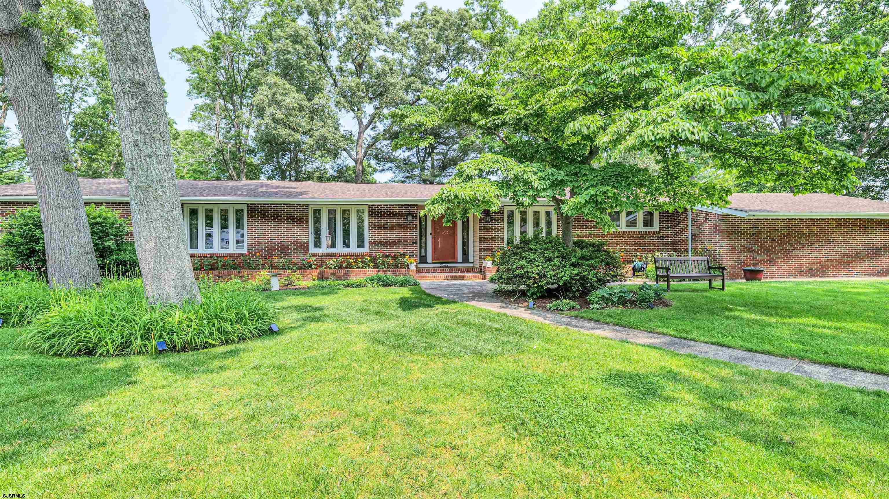 Gorgeous and Huge Rambling Rancher… 2760 sq ft! It is in the heart of Northfield at the end of the prettiest cul-de-sac anywhere! Beaches, parks, and schools are only 10 minutes away. This is a very well-maintained home where beauty abounds in every room with designer touches, art gallery style painted rooms, modern lighting, eye-catching custom window treatments and beautiful hardwoods. The main floor is over 2100 sq ft and the finished portion of the basement is 660 sq ft.  Step into the front door of the primary living space which has everything you want, all on one floor. You have an enormous living room, a den with a big brick gas fireplace and a slider leading outside to a X-LARGE (600 sq ft) deck overlooking a park-like setting in the backyard. Back inside is the beautifully updated, open kitchen with quartz countertops and a long island and wine fridge. The dining room has beautiful windows and a French door. Off the kitchen is the laundry room, a ½ bath and an oversized 2 car garage. Walk down the hallway to find 3 bedrooms. The large master bedroom suite has a private bath, makeup/vanity area, with plenty of closet space. Next you see 2 large bedrooms and an updated full bath keeping with attractive original Italian tile.  The walk-out basement is a stunning finished space (660 sq ft) that looks like a hotel suite with a living room, bedroom, large bathroom with shower, and its own patio.    The unfinished portion of the basement is great for storage!  The fenced yard has mature trees, flowering bushes and is equipped with a well-water sprinkler system.  All measurements are deemed reliable but please verify for yourself.