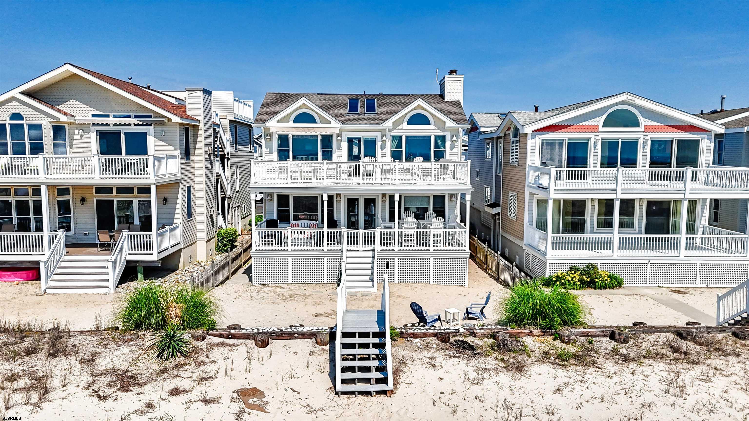 Prime, quiet southend, 2nd floor beachfront location! This stunning 2nd floor home offers panoramic ocean views and luxury living at its finest. Spanning 4 bedrooms and 2.5 bathrooms, this open concept floor plan showcases a large beautifully decorated living room, and a stunning custom kitchen equipped with granite counters, high-end appliances, and a private wine fridge. Enjoy the cathedral ceilings, fabulous ocean views, and direct access to your huge ocean front deck, perfect for soaking in picturesque sunrises, or enjoying cocktails in the evenings. The master suite offers a luxurious en suite bath with all new tile and granite, and double sink. This home also includes a private enclosed garage, and a private enclosed outside shower. With a new roof, 2024-25, this home is like-new construction! Move in ready and packed with luxury upgrades, this beachfront home delivers the ultimate Ocean City life style, close to great restaurants, shops, and of course, endless beach fun!