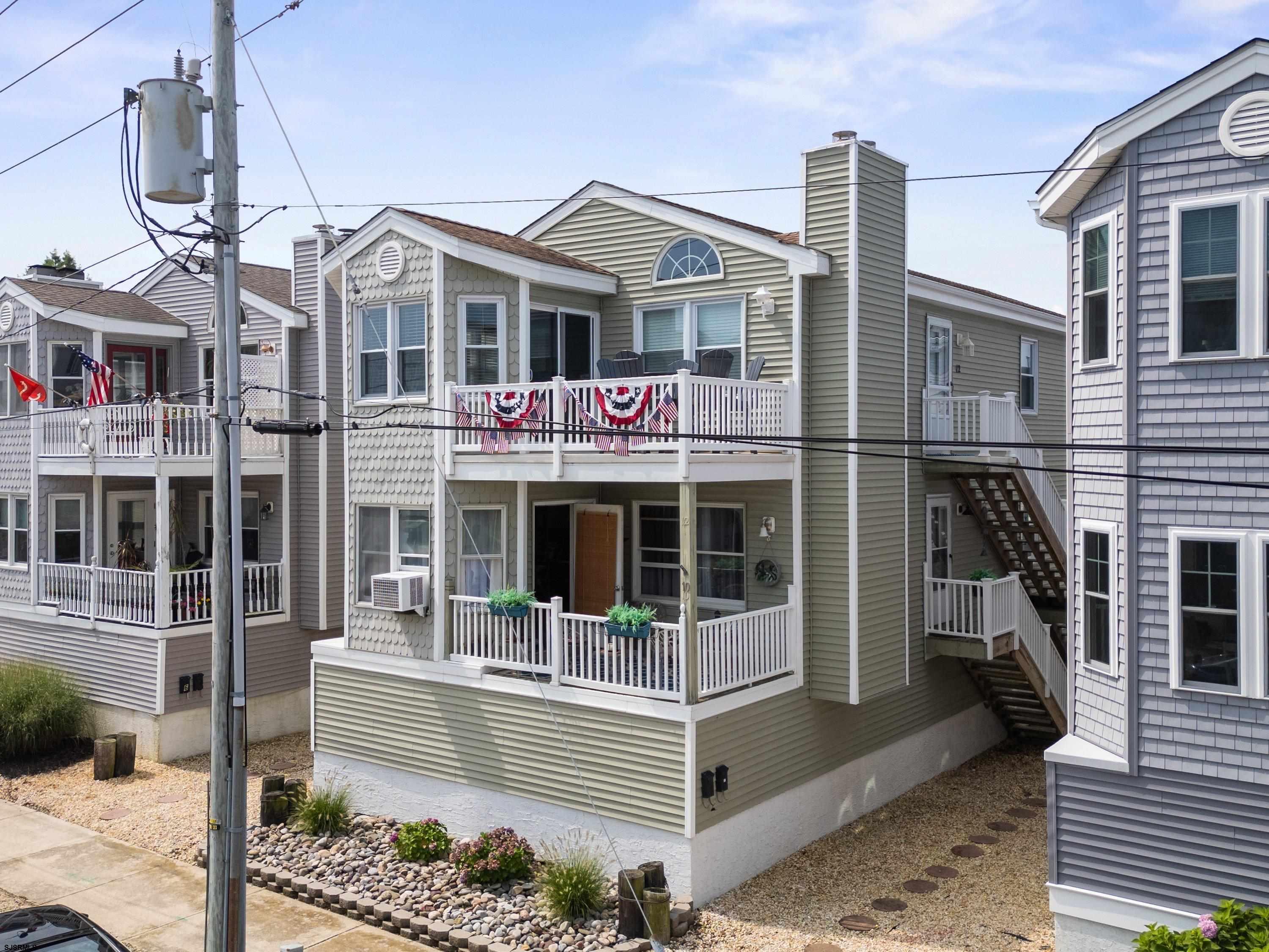 Don’t miss this well-maintained 2nd floor condo with stunning bay views in Ocean City’s desirable North End! This affordable 3-bedroom, 2-bathroom home offers spacious living with cathedral ceilings and an updated kitchen featuring new cabinetry, stainless steel appliances, and granite countertops. Recent upgrades include a brand new HVAC system (2025), hot water heater, washer and dryer, all new windows, and a rebuilt exterior staircase with new treads — making this a truly move-in ready property. Additional features include central air, low-maintenance vinyl siding and railings, private outdoor shower, attic storage, ground-level private storage, and off-street parking and garage port for up to 3 cars. Unwind on the front deck and enjoy beautiful sunsets and bay views after a day at the beach. Just a short bike ride to the beach, boardwalk, and downtown shops — this condo blends comfort, convenience, and coastal charm. Call today to schedule your private tour!