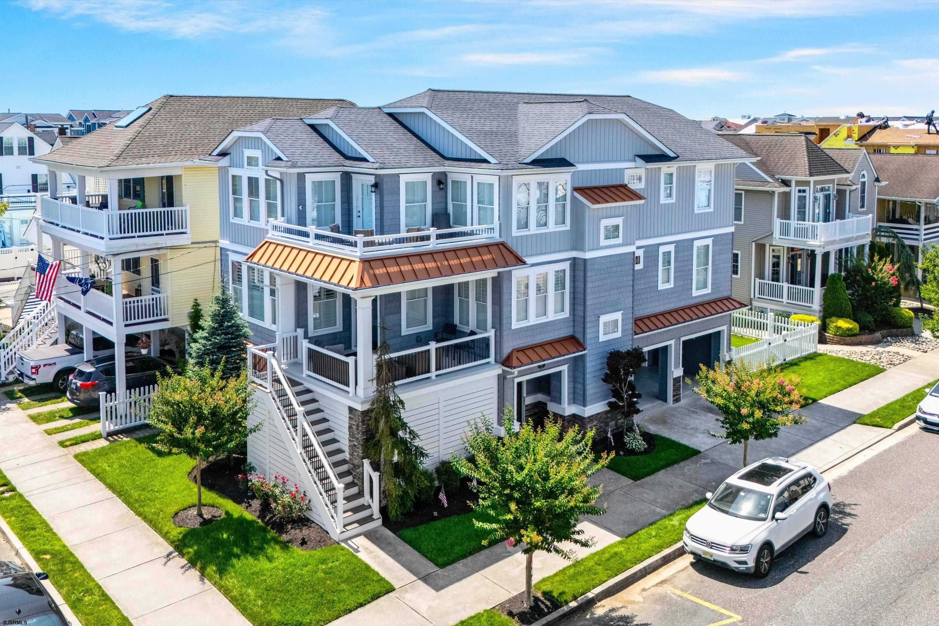 Stunning First Floor Corner Condo in a Prime Location! This beautifully maintained, like-new property features 4 spacious bedrooms and 2 full bathrooms, offering a perfect blend of comfort and upscale coastal living. Enjoy a bright and open great room with beautiful custom moldings and baseboards, hardwood flooring that flows into the hallway and master bedroom. The custom kitchen with stainless steel appliances, large center island w/Cambria Quartz countertops and extra seating, a stylish tile backsplash, ample storage and just off the kitchen is a generous dining area to gather family and friends. Additional highlights include: Front covered deck, Tiled shower/tub combinations with frameless glass doors in both bathrooms and granite vanity tops, tankless hot water heater. Private entrance and attached 1-car garage with epoxy flooring, and adjacent fenced side yard complete this amazing Beach Home.   This immaculate property located at the corner of 19th & Central Ave is just steps to the beach and access to the boardwalk, a great condo in a perfect location!  Easy to show.