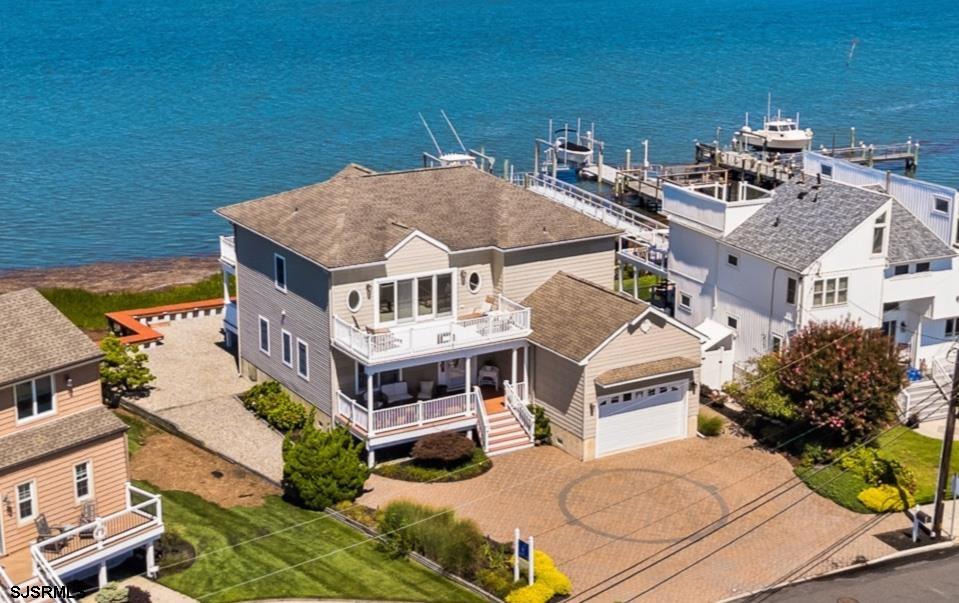 Picture yourself relaxing as the sun sets over the bay, casting vibrant hues across the sky and creating a breathtaking backdrop for your evenings. This is the lifestyle that awaits you in this custom stunning 3,064 sq ft bayfront home, where every sunset becomes a captivating experience. Embrace the tranquility of waterfront living and create unforgettable memories in your own serene oasis! The innovative reverse floor plan is designed to maximize stunning views of the bay, ensuring that you can enjoy the breathtaking scenery from your main living spaces. Experience the ultimate in comfort and convenience with four generously sized bedrooms, including two luxurious suites. Each bedroom offers ample space, perfect for relaxation or personalization. The two ensuite bathrooms provide an added touch of privacy and sophistication, making mornings a breeze and creating an inviting atmosphere for guests. This thoughtful layout elevates your daily living experience, as you soak in the beauty of the bay from the comfort of your home.  The soaring vaulted ceilings enhance the spaciousness, allowing natural light to flood the open living areas, creating an inviting atmosphere. The thoughtfully designed open floor plan features a stunning gourmet kitchen with rich hardwood cabinets and an expansive island with bar seating—perfect for hosting gatherings and creating lasting memories with family and friends.  Transform your living experience with stunning warm cherry wood hardwood floors that flow seamlessly throughout the home, exuding elegance and comfort. Step outside onto the oversized decks, designed to enhance your lifestyle and showcase breathtaking open water views. Whether you're entertaining guests or enjoying a peaceful morning coffee, these spacious decks offer the perfect backdrop for every occasion.  This property masterfully combines a warm, inviting atmosphere with the luxury of its prime waterfront location. Located near Brigantine's renowned Golf Links, public bay access, the seawall, and the ocean, as well as nearby schools, dining, and shopping, this home truly offers the ultimate coastal lifestyle. Don’t miss your chance to make this stunning sanctuary your own!   The sellers navigated the process of obtaining CAFRA approvals to build a dock , along with securing a riparian lease during the home's construction. They ultimately chose not to proceed with the dock installation and allowed the riparian lease to lapse, this presents a unique opportunity for the new owner. The new owner will need to initiate a fresh application process and conduct their own due diligence to explore the possibilities of waterfront enhancements.  Some of the photos have been virtually staged to highlight the home’s potential and inspire your imagination.