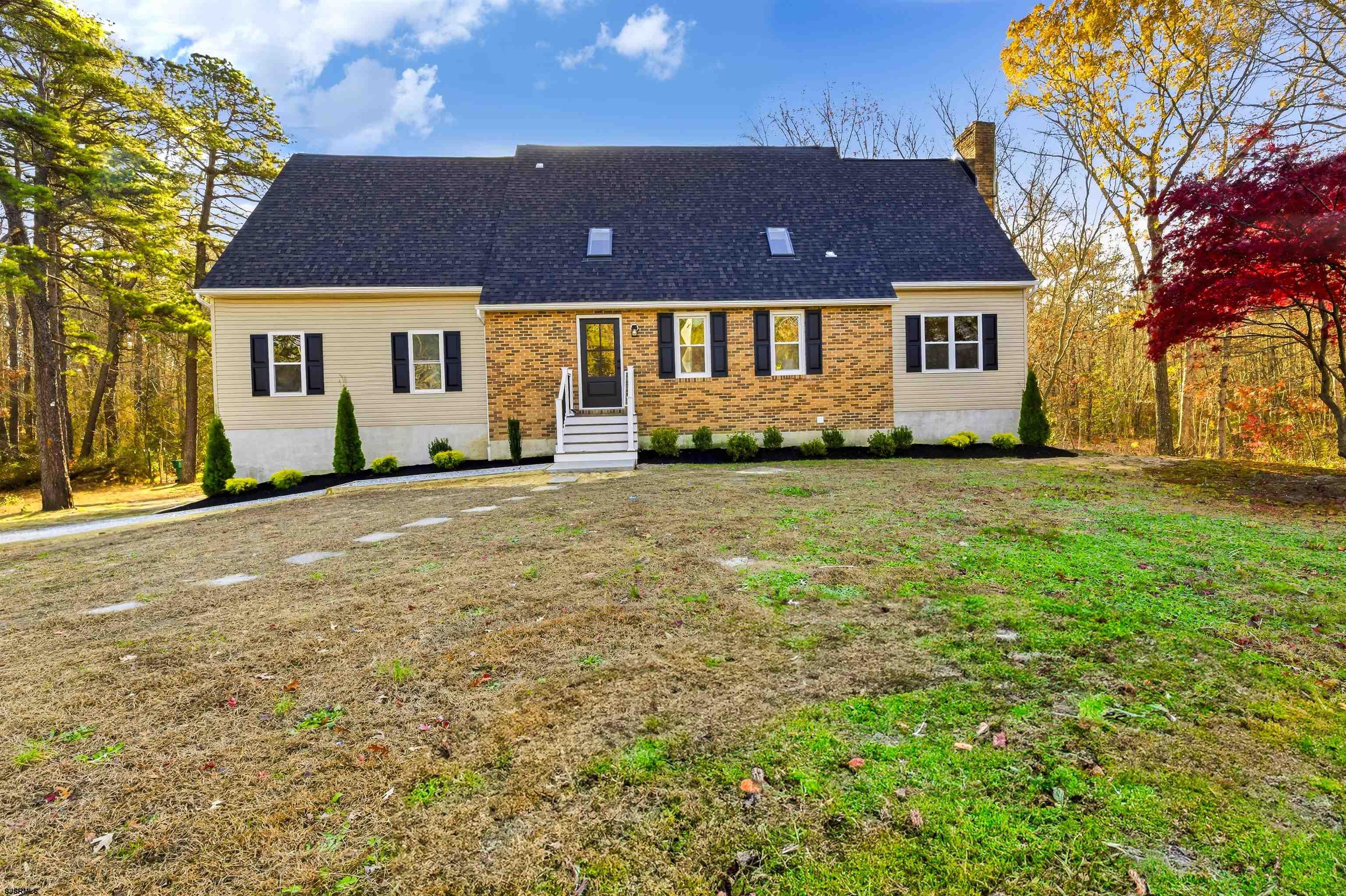 Welcome to this beautifully renovated 4-bedroom, 2.5-bathroom home situated on 5.93 private acres, offering modern living and exceptional craftsmanship throughout. Step inside to find a bright and open floor plan enhanced by luxury vinyl laminate flooring. The gourmet kitchen is a standout, featuring white shaker cabinets, a modern backsplash, stainless steel appliances, quartz countertops, and a huge island perfect for entertaining. The formal living room impresses with soaring vaulted ceilings, while the cozy family room features a classic wood-burning fireplace. Just off the kitchen is a convenient half bathroom and a versatile flex space ideal for a playroom or home office. Upstairs, the spacious primary suite offers two closets and a stunning modern bathroom with beautifully designed tile finishes. Three additional generously sized bedrooms and a sleek full bathroom complete the upper level, providing comfort and style for the whole household. The property includes a 2-car garage and a full unfinished basement offering endless potential for additional living space or storage. Set on nearly 6 acres, this home provides privacy and room to roam. Major upgrades include a brand-new roof, new siding, new windows, new HVAC system, and a new septic, and conversion to gas—ensuring peace of mind for years to come.