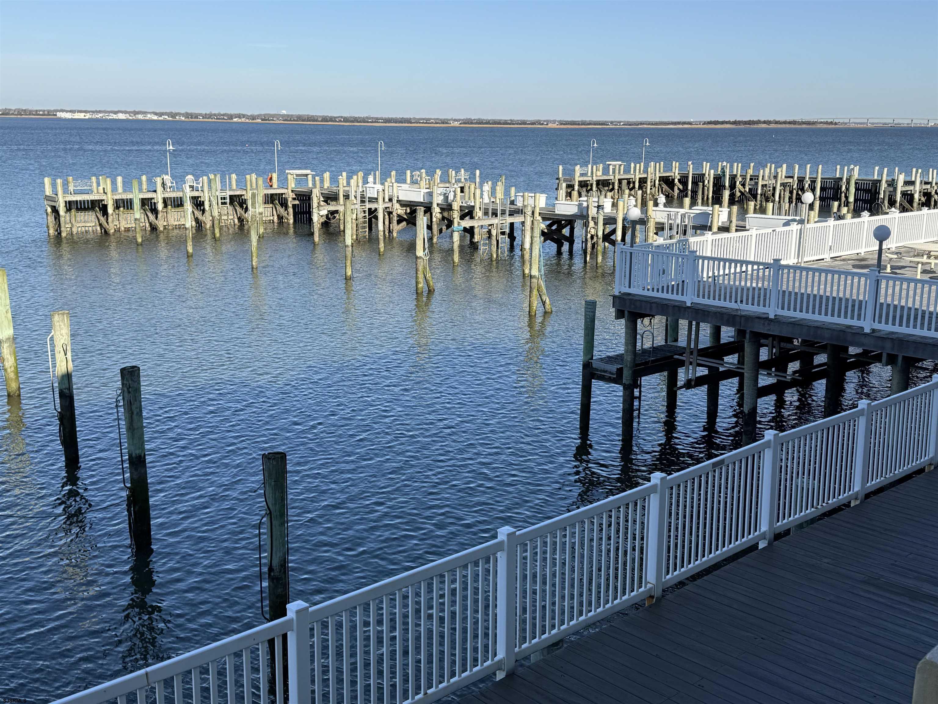 Experience bayfront living at its best in this stunning WATERFRONT summer rental at Harbor House, located in the north end of Ocean City. This second-floor end unit offers spectacular bay views and incredible sunsets. The property features 1BR/1BA, a full kitchen, washer/dryer and excellent amenities; including fishing right at your doorstep, a relaxing pool, and a bayfront sundeck and  barbecue area. You will be just steps away from Dockside Kitchen and conveniently close to watersports, boat rentals, and fishing spots.  The unit is available for weekly and monthly June and August.   SUMMER RENTAL! *Monthly rates available for August only