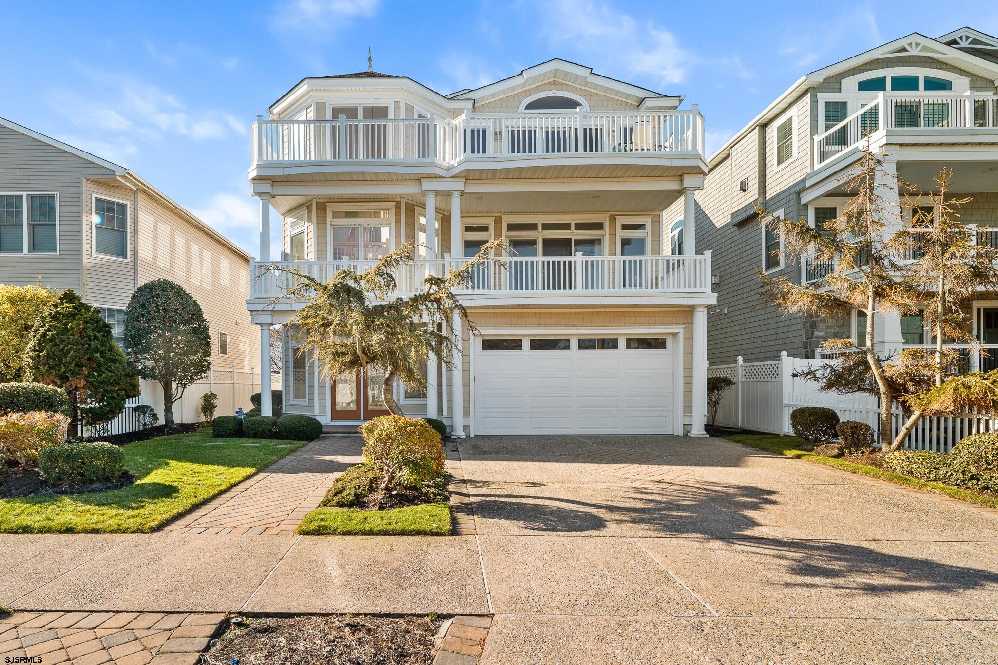Just four properties to the beach in desirable Brigantine, this exceptional three-story coastal residence is the definition of elevated shore living—crafted for those who want the luxury of space, light, and effortless entertaining wrapped in a true beach lifestyle. With 5 bedrooms, 3.5 baths, a 2-car garage, and an elevator servicing every level, the home is designed to welcome generations of family and friends with ease, from sun-soaked summer weekends to elegant off-season escapes.  The experience begins where beach living belongs—on the third-floor main living level, where vaulted ceilings and a flood of natural light pour through expansive windows, creating an airy, uplifting atmosphere all day long. An open-concept layout connects the heart of the home: a timeless kitchen with crisp white cabinetry, stainless steel appliances, granite countertops, and a generous island perfect for gathering over coffee, cocktails, or fresh coastal fare. Tucked into a charming alcove, the kitchen seating area opens to a private deck with some ocean views, inviting slow mornings with sea breezes and golden light. The dining area flows beautifully into the family room, where one of three stunning tiled fireplaces anchors the space with warmth and style—complete with custom shelving and a TV—before opening to an expansive deck made for sunset dinners, lively entertaining, and listening to the rhythm of the shore.                                                                  The second floor is a private retreat, anchored by a stately primary suite positioned at the front of the home. A beautiful fireplace adds a boutique-hotel feel, while the spa-inspired bath features a jacuzzi tub, walk-in tiled shower, and a large walk-in closet. Step outside to your private deck and take in the coastal air—an ideal spot for morning quiet or evening unwinding after the beach. Down the hall, a generous open landing creates the perfect library or sitting lounge, leading to two spacious bedrooms—each easily accommodating king-size bedroom furniture—and a shared bath with an expansive white double vanity and a beautifully finished tub/shower combination.  On the first floor, the home welcomes you with elegant tilework and a relaxed, resort-style vibe—complete with a full bar area and a large family room centered around another dramatic tiled fireplace. Sliders open to a private outdoor patio framed by lush landscaping, and after long days on the sand, the outdoor enclosed shower becomes one of those everyday luxuries you’ll wonder how you lived without. Two additional spacious bedrooms—one currently styled as an office—share a full bath featuring a double white vanity and a beautifully tiled walk-in shower, offering flexibility for guests, work-from-home, or a private wellness space.  Perfectly positioned for the best of Brigantine, you’re not only steps from the shoreline, but also a walk to the center of town, where shopping, dining, and coastal charm complete the lifestyle. This is more than a home—it’s a refined beach escape designed for comfort, connection, and unforgettable shore seasons.