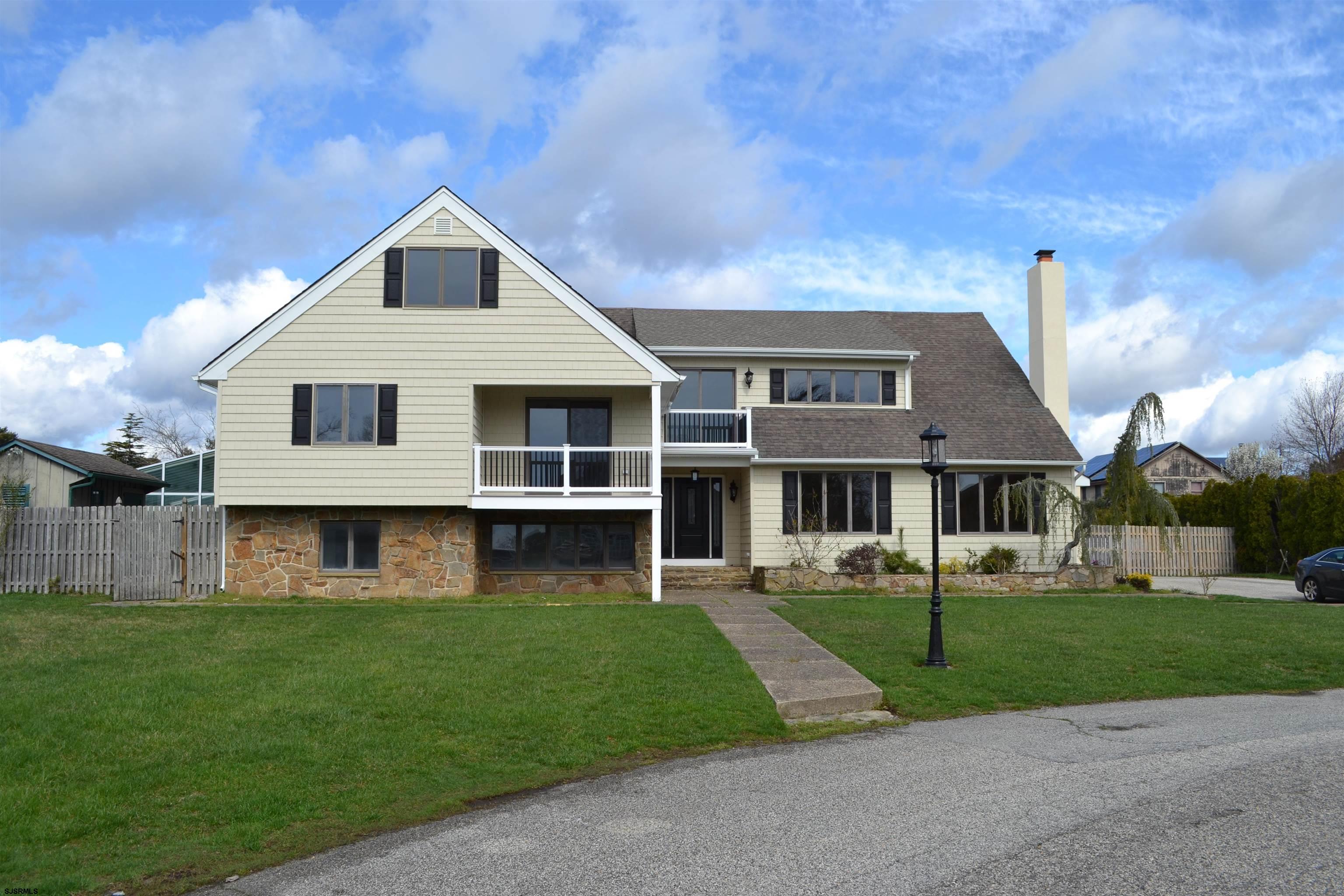 Executive home with 7 bedrooms, 5.5 baths. This home has been fully renovated and shows beautifully. Hardwood flooring throughout. Gourmet kitchen with a chef's (6 burner) stove. There is one bedroom on the lower level and six more on the upper levels. Large master suite with a walk in closet and a custom tiled bathroom with separate tub and shower. This home also features a large indoor pool for year round usage. Located in a quiet, high end neighborhood by the golf course.