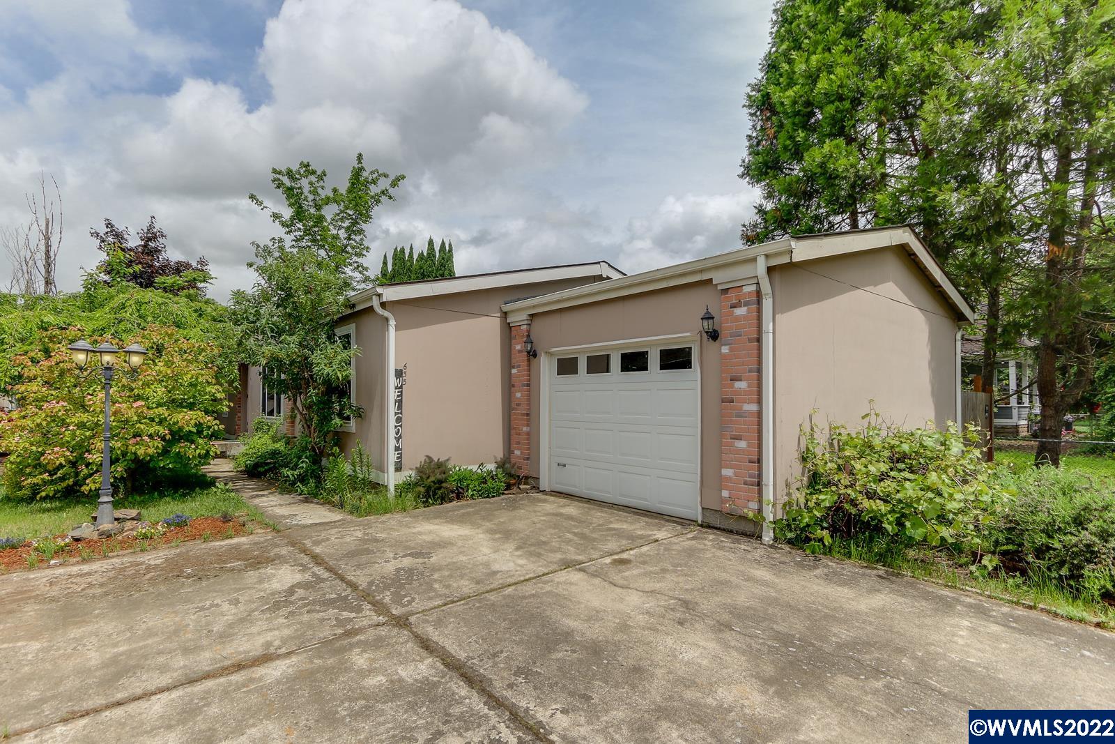 Nice & cozy home on own lot. Fresh interior paint, soaker tub, eat bar, single car garage. Includes all kitchen appliances. Central air and heat. Two decks, one off kitchen, one in fenced back yard, has alley access with additional parking outside fence. Fig tree. Convenient to town and I-5 commute