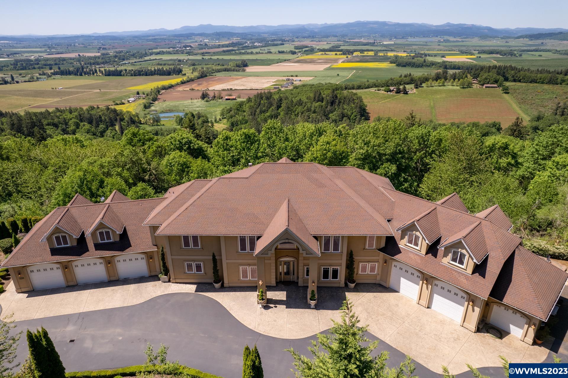 West Salem gated estate with 180 degree vineyard, valley & coastal range views. Featuring Brazilian cherry wood floors, granite counters, custom wood built-in features, hydronic radiant heated floors and top of the line smart home and security features. Offering a spacious yet functional floor plan which includes executive office, gourmet kitchen, formal dining room, media room, gym space, and finished basement with kitchenette. Situated on 4.77 acres and featuring a 6 car garage w/oversized bays for RV.
