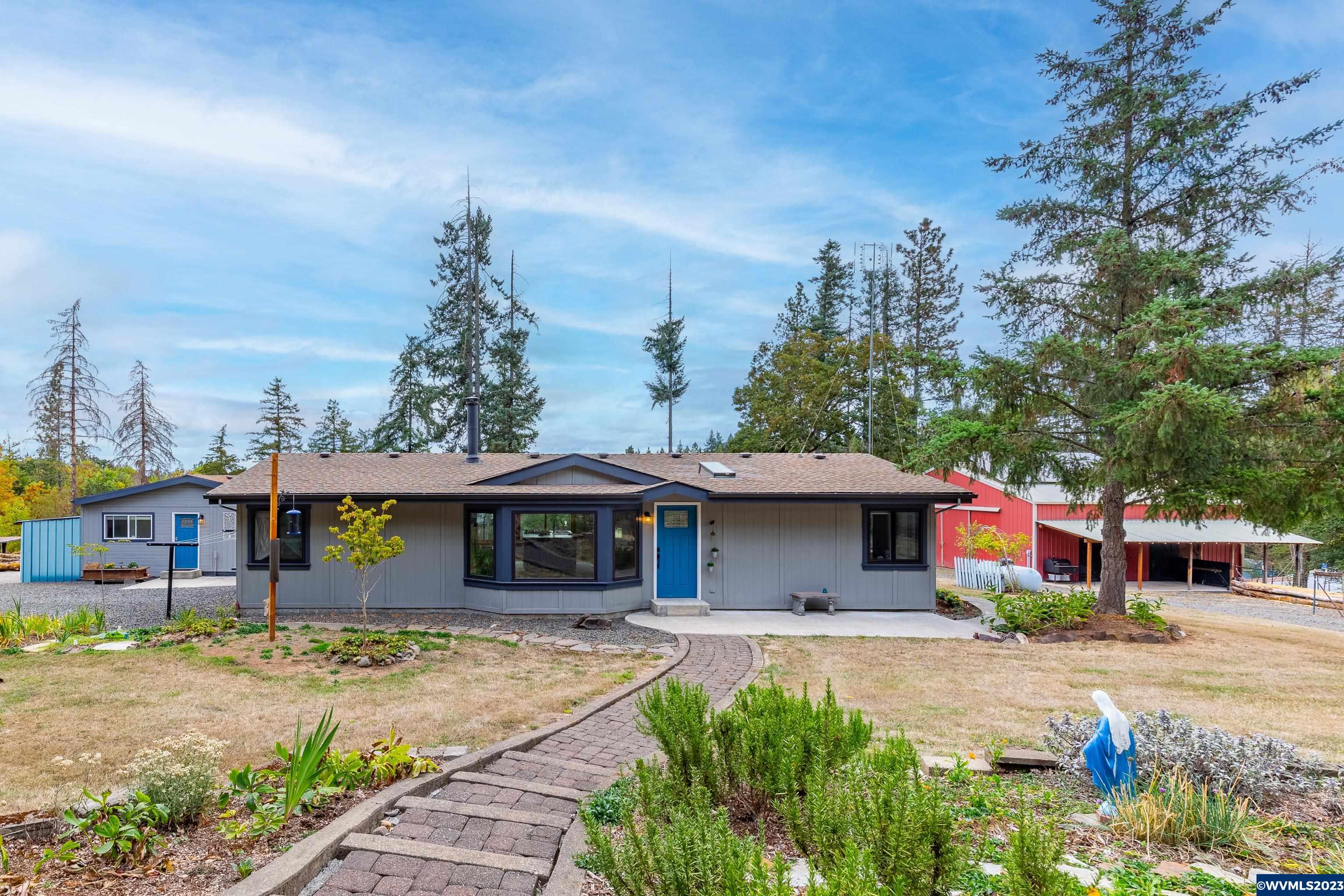 Welcome to your 2-bed, 2-bath manufactured home on almost 5 acres. With an electric gate, circular driveway, and full fencing. The barn with solar panels, chicken coop, and spring-fed orchard make it perfect for farm enthusiasts. Enjoy clean water from two cisterns and a filtration system, plus a concrete patio with stunning views. General purpose building with a full kitchen and bathroom. This property embodies pride of ownership and serene country living. Schedule your viewing today!
