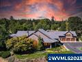 Incredible custom home offers elegance & seclusion amidst the back drop of the Cascade ranges. The front & rear covered porches offer the ability to relax & take in the seasonal ponds that bring in wild ducks & geese. 20ft ceilings, open floor plan & expansive picture windows offer a perfect space for entertaining. Vast main bathroom w/ dual closets, sinks & heated bathroom floors. Dual living poss. w/4bedroom, full bath & bonus room above garage. 5-bay shop, meticulously landscaped grounds- a rare find!