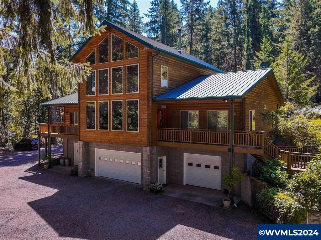 Exquisite 3 bed, 2.5 bath, 2784 sqft home with high beam ceilings, large loft, abundant windows framing scenic views, and a metal roof. Set on over 7 acres that backs up to 1300 acres of managed timber with current access from your own backyard to hunt, walk, hike etc. This home includes a spacious covered back deck for outdoor relaxation, a 3 bay garage with lots of room for your cars or storage and a large machine shop. Embrace nature and serenity with this one of a kind home.