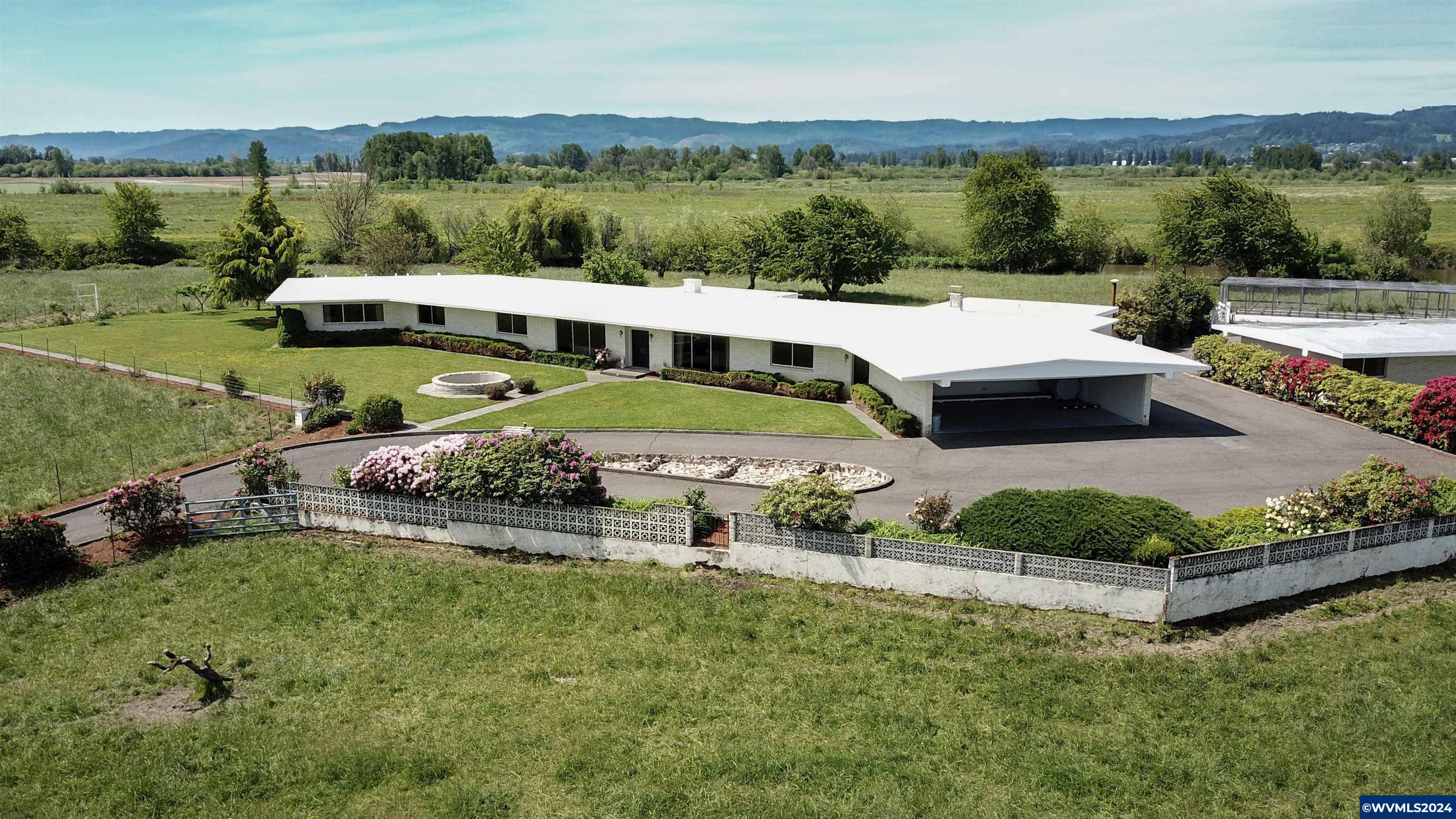 Mid-Century Modern:  Main House is original, 6,317 sq ft built in 1966.  2nd House:  1,701 sq ft built in 1968.  3rd House:  1,447 sq ft built in 1946.  (total 9,948 finished sq ft) Top quality finish & materials.  Brick exteriors, built-ins, marble, custom woodwork.  Chester Gunderson (Gunderson Bros. Engineering) built main house sparing no expense.  Refer to documents or search online for Gunderson Brothers history in PDX area, including WWII era naval contracts.   129 +/- acres on Multnomah Channel. 4,800 sq ft brick barn/shed.  Nature, waterfowl, recreation, fishing & privacy.  Historic home & acreage borders Multnomah Channel which connects to the Columbia River.  Only 10 minutes to shopping/services in Scappoose & 30 minutes to Portland Metro area.  Property located inside Scappoose Drainage Improvement District.