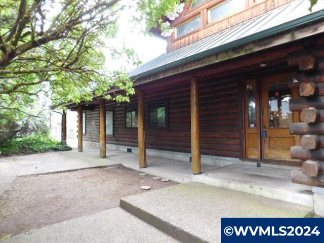 Exceptionally well built log home on nearly half acre.  1000 sf shop with bathroom.   This home appears to have particularly fine craftmanship.  Beautiful covered porch.  In ground pool & spa.  Mature trees & fencing create a unique private setting.  All bedrooms are large including the primary that is on the main level.  With a little cleaning this is a great value.  Lots of light & windows throughout including the enclosed sunroom.  Attached garage is oversized at 22 x 36.