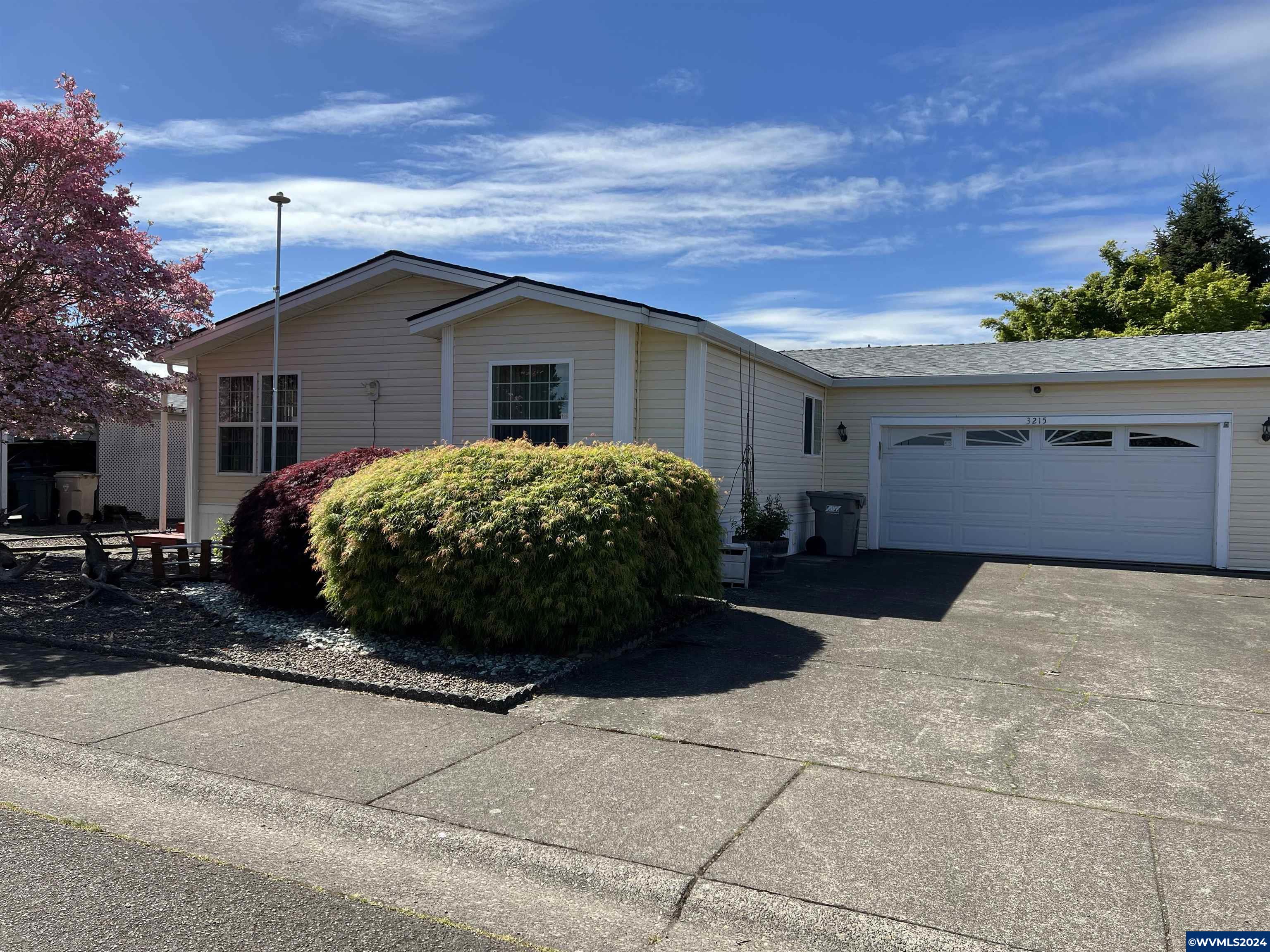Come and see! This beautiful 2bd/2ba 1512sf MFG home, with loads of storage, on it's own land on the west side of town. Well maintained home with new kitchen cabinets,countertops, all flooring in 2018, deck re-stained 2023, lovely fully fenced backyard with pond, covered patio with outdoor sink, automatic sprinkler system on entire property, low maintenance vinyl siding and windows in 2006, 2-car garage and considerable amount of additional parking space.