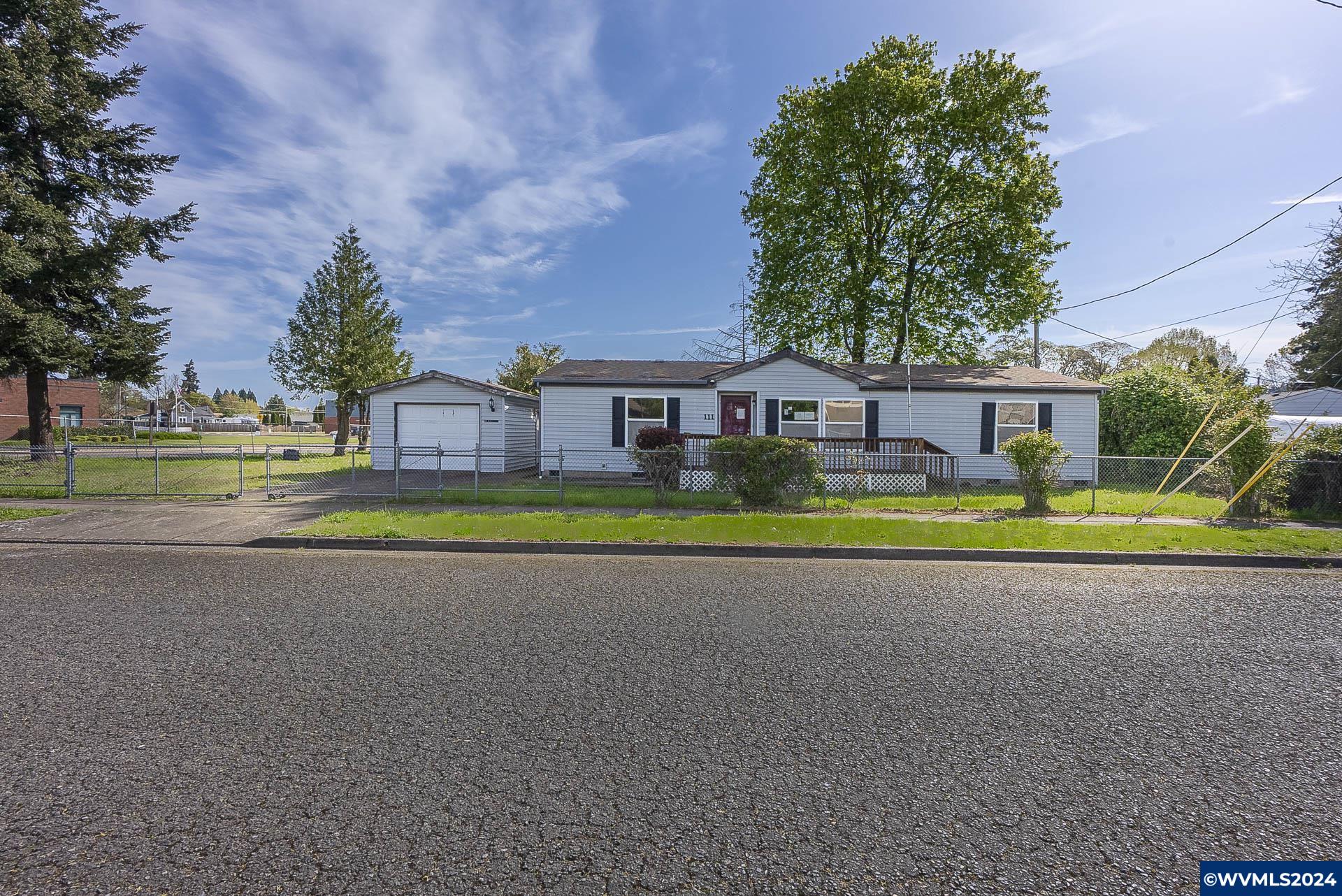 The corner lot, has a stand-alone, nice detached garage. Completely fenced. Not in a park, no HOA! Enormous back covered deck and several outbuildings. Water feature. This property may qualify for Seller Financing (Vendee).