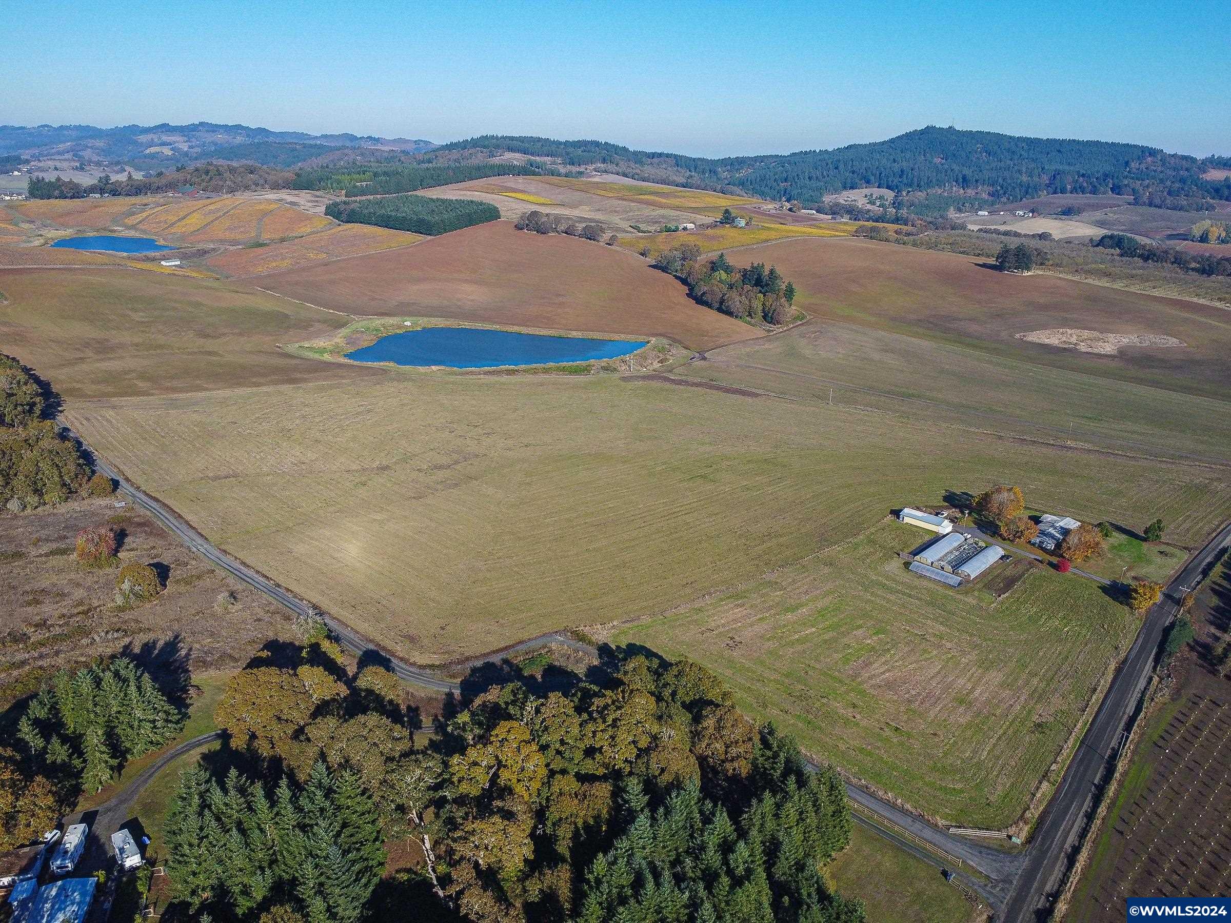 Accepted Offer with Contingencies. 214.45 acres offers excellent tiled vineyard land; slope, elevation, and S/SE aspect with 68.4 acres of water rights. This property is located on the outskirts of Salem, Oregon, among several well-known vineyards and wineries, Cherry Hill Winery, Eola Hills & Wahle Vineyards. Currently in Grass seed production and a cherry orchard. Irrigation Pond is stocked with bass and bluegill. Grass tenant willing to terminate lease.