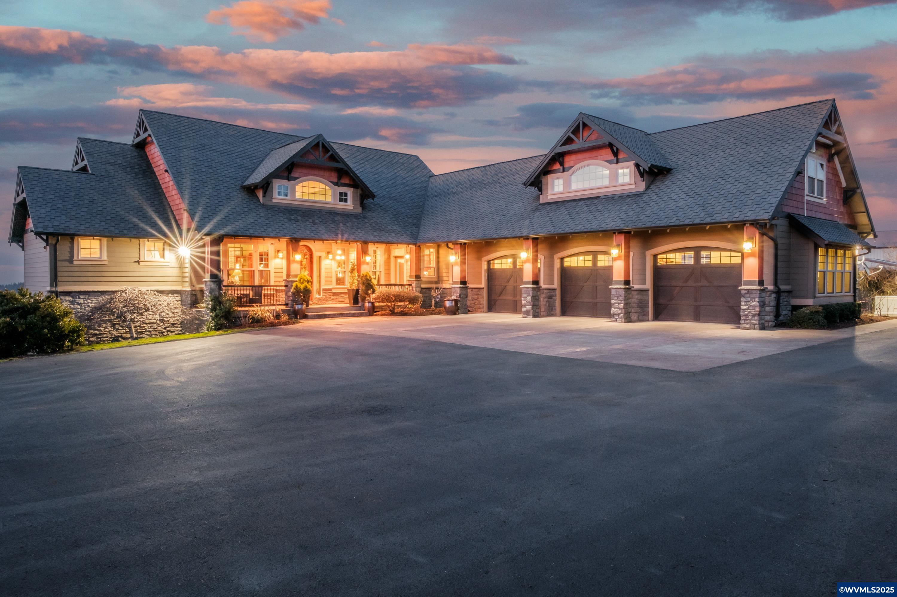 Grand View perfectly captures the breathtaking panoramic mountain views offered by this property, located in Oregon's wine country. Custom timber frame home with luxury amenities. Chef’s kitchen, 2 bonus rooms that could be additional bedrooms.  Amazing master suite, large covered decks for entertaining.  Equestrian facility with 4 stalls and 72X72 Covered Arena, 48X48 Shop, 3 car garage, adorable gardens and chick coop, generac generator, solar powered-no power bills, gated driveway. This property is in one of Oregon’s Wine Regions with one popular winery located just minutes from the property and visible from the horse arena (Paradis Vineyards). As you enter the property you are greeted by a massive wrought iron electronic gate and paved entrance. This special property will steal your heart away with its elegant timber frame design. Giant vaulted ceilings and wooden beams greet you as you enter the front door and are awed by the views. Located on the main level is the primary suite, study, formal dining, great room, kitchen, and an additional bedroom and bath, along with a laundry/mud room with a separate entrance. The kitchen is a chef's dream, featuring a large island perfect for entertaining, a propane cooktop, three ovens, a plumbed coffee station, all granite counters, and breathtaking views. This culinary haven opens to a spacious deck, designed for entertaining with its own fireplace and television. The great room, adjoining the kitchen and dining areas, offers a fantastic view of majestic mountains and a glimpse of Portland lights at night. A stone fireplace with a Heatilator. The lower level of the home boasts a family room with a 190-degree view of mountains and Portland lights along with two additional bedrooms and one bathroom. An oversized three-car garage includes a canning kitchen, a dog-wash station and RV hookup. A soil report shows soil on the property to be 96% Nekia Silty Clay Loam with 12-20 percent slopes which may be ideal for a small vineyard. The 3-bay shop, measuring 48X48, is equipped with concrete floors, 220 power, and tall rollup doors (14-foot doors).  The 72X96 Horse Arena Building features four stalls, tack room and is ready for your wash rack. The property includes three acres of Christmas trees that are 3 years old. The property benefits from sixty solar panels located on the arena barn roof which supply power to the entire property, ensuring energy efficiency and sustainability. The home has a Generac backup.