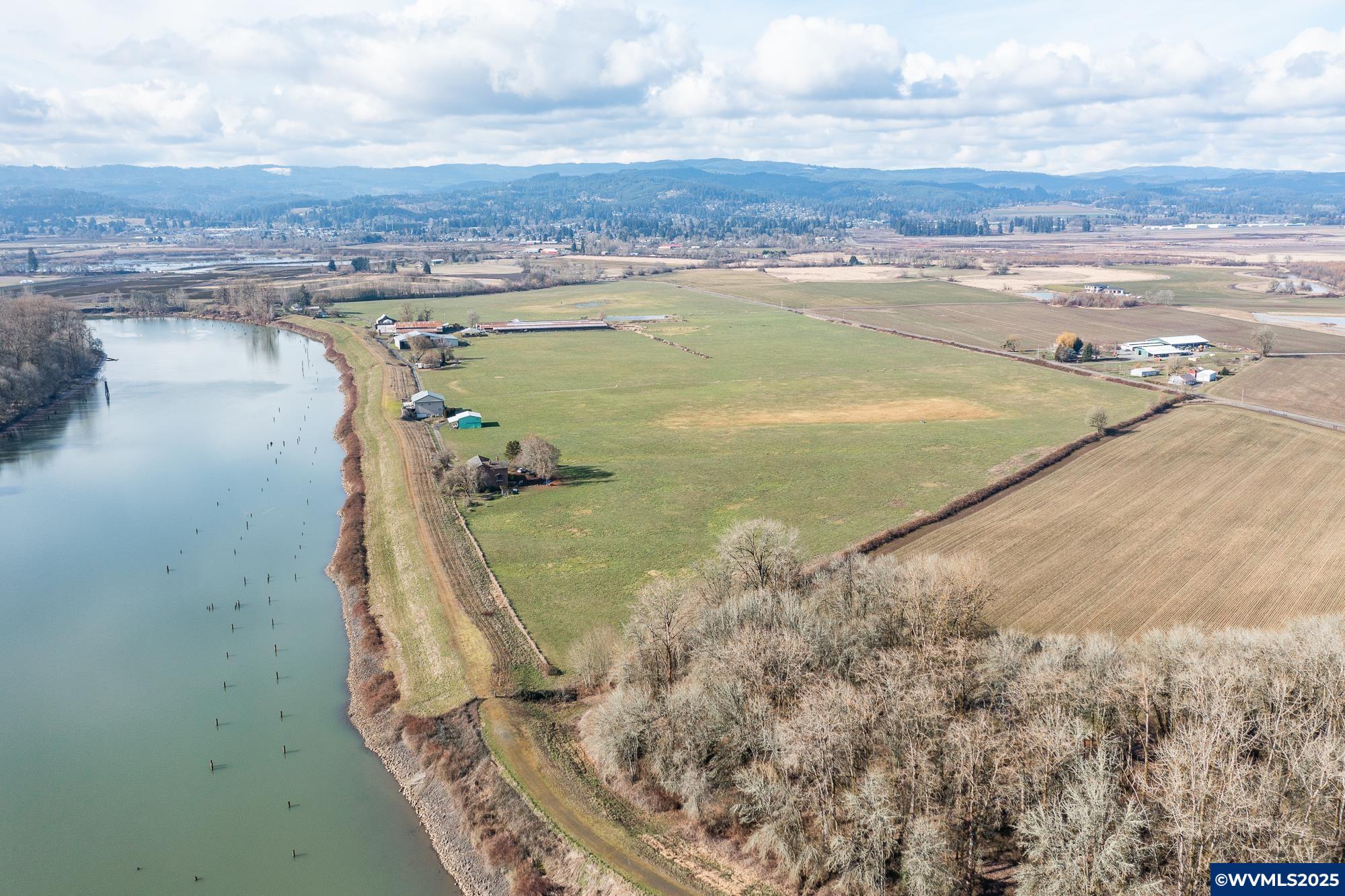 This 102-acre riverfront farm features four houses, nearly an acre of outbuildings, excellent soils, and strong water rights. Once a thriving organic dairy, it’s ready for your vision. Continue with grazing and livestock, expand into specialty crops, or focus on rental income including the outbuildings. The homes could be elevated for stunning river views. Explore the potential for a private dock, houseboats, or even agritourism. With prime river frontage, this rare property offers endless possibilities.