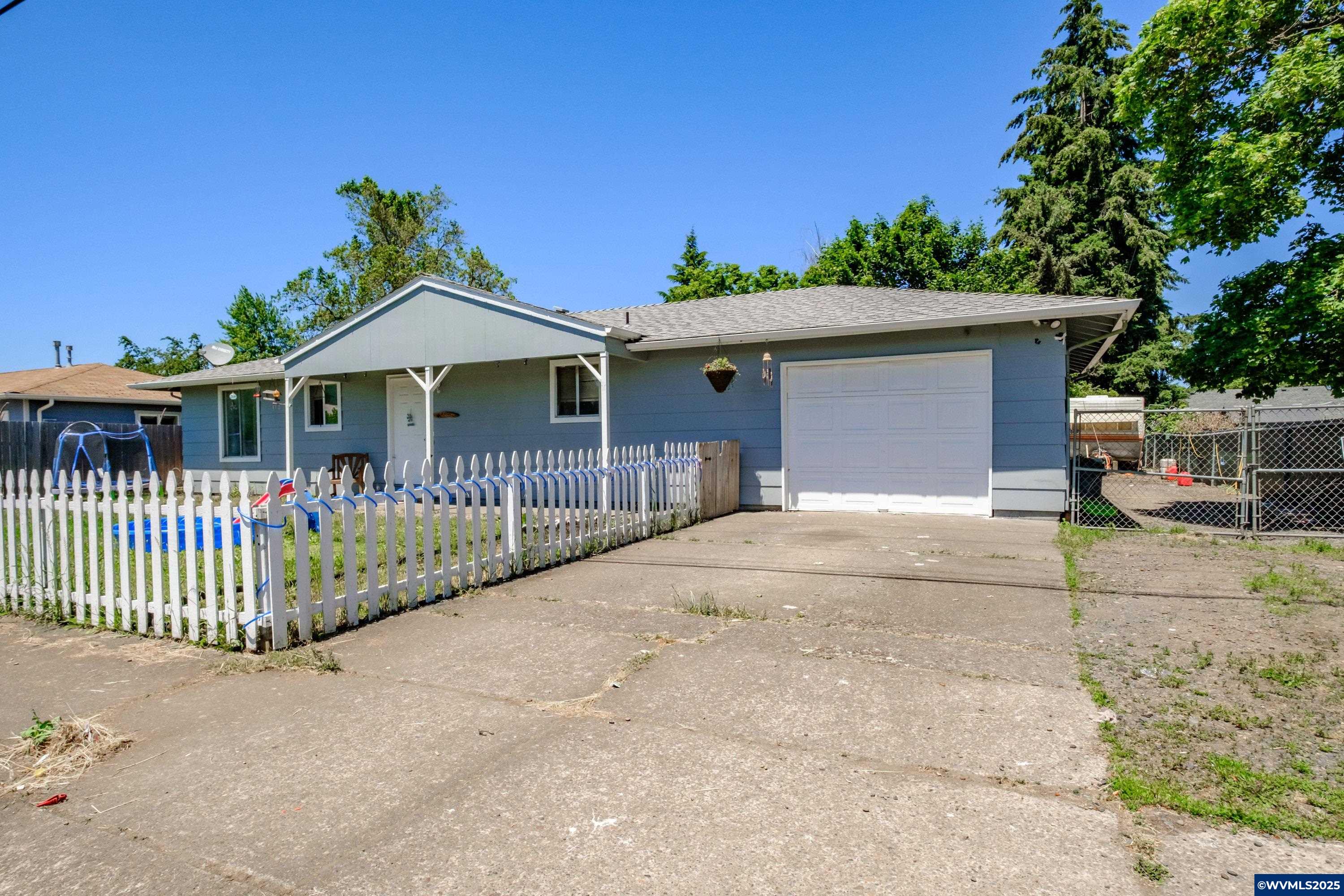 Just what your looking for to give you that affordabilty your looking for... 3 bedroom  single family residence on large lot, Covered front porch relax take in the views of the good old fasion white picket fenced front yard. Enjoy nice size covered patio in the very large fenced backyard for all your entertaining with friends and family. Great sized gravel area behind gate for RV or extra parking.. a little tlc can go along way with this one!! $5,000 flooring credit toward Buyers closing cost!!